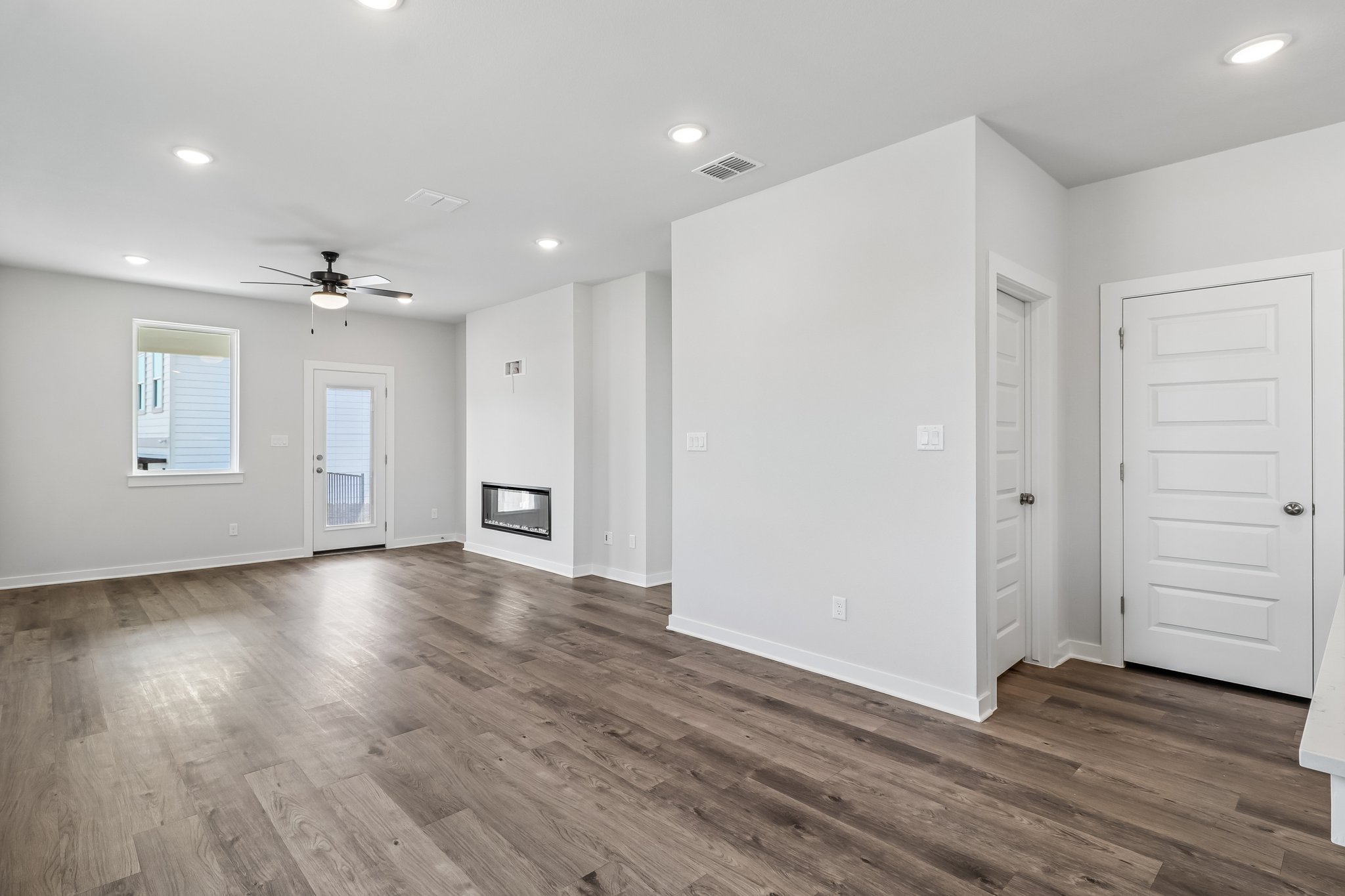 A room with white walls and a wood floor.