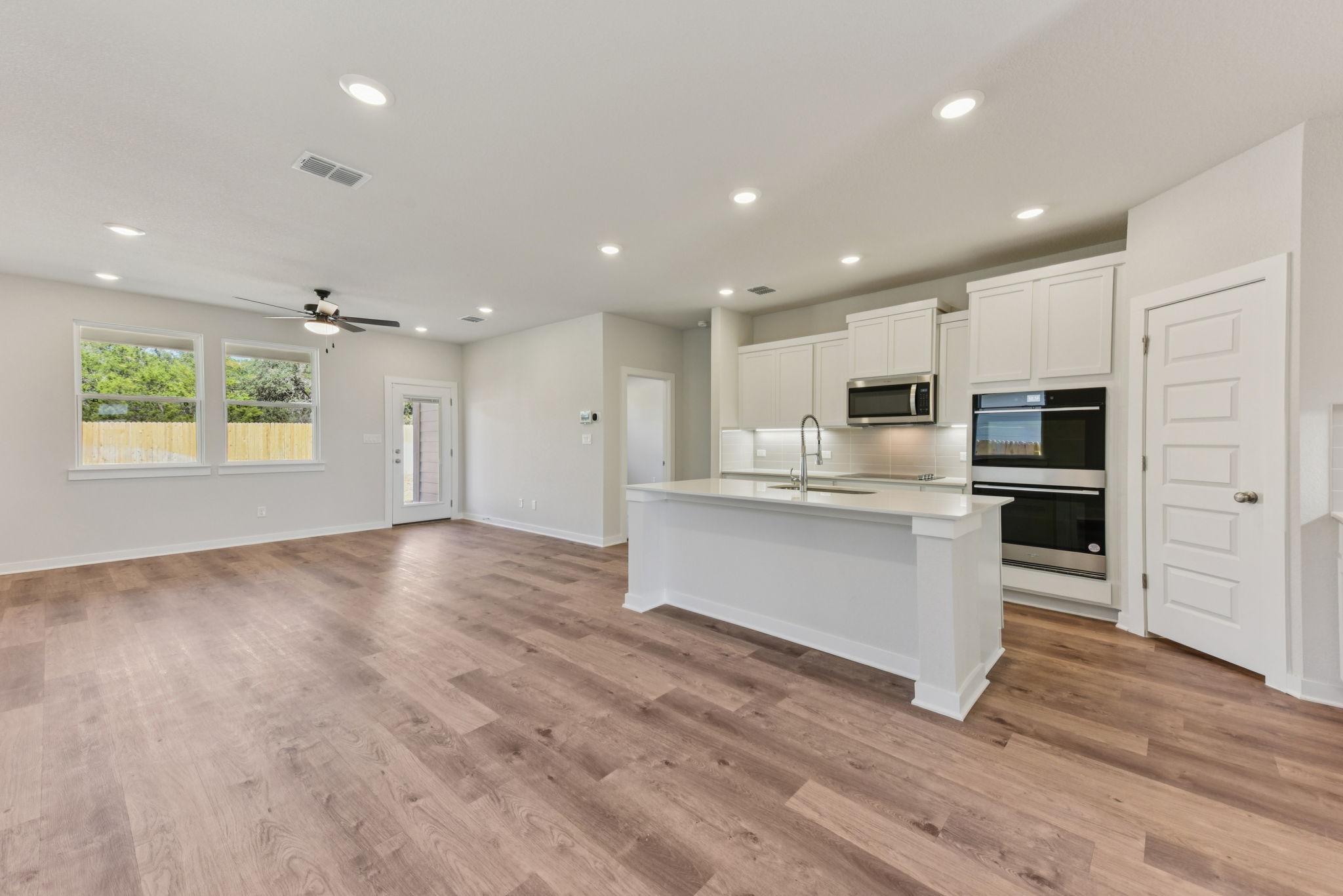 A kitchen with white cabinets.