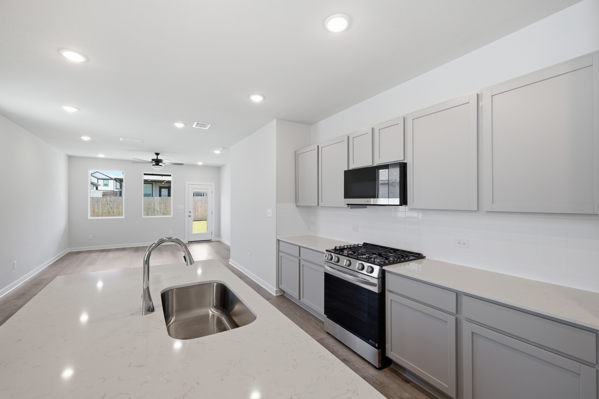 A kitchen with white cabinets.