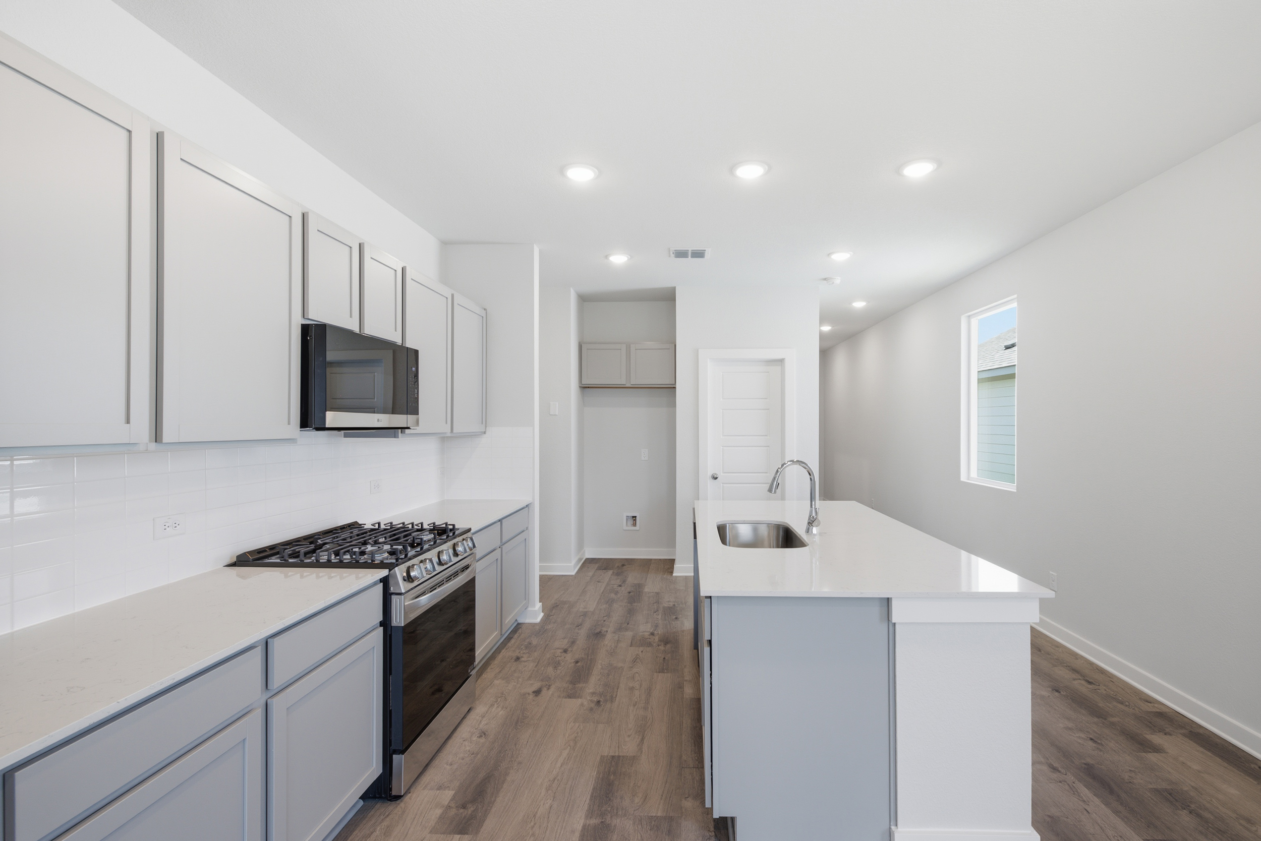 A kitchen with white cabinets.