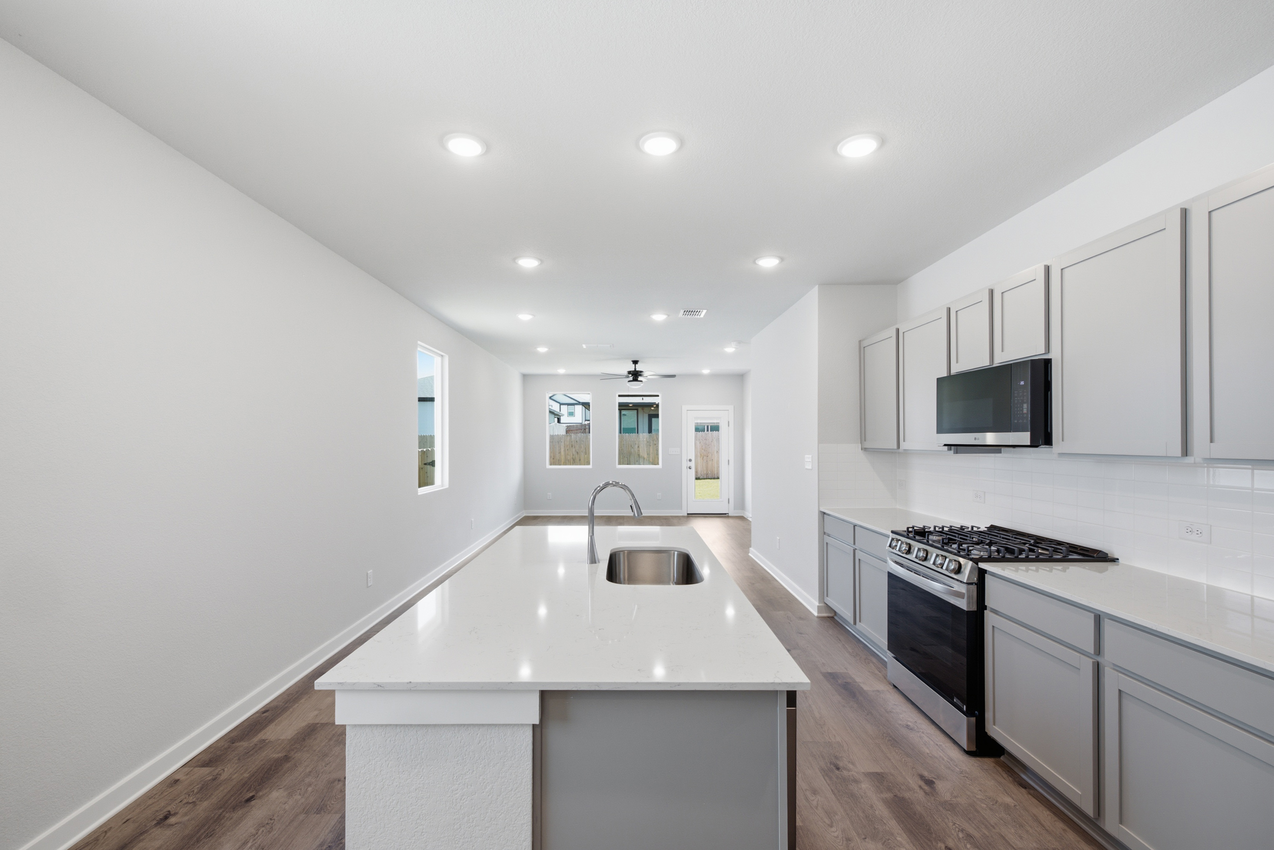 A kitchen with white cabinets.