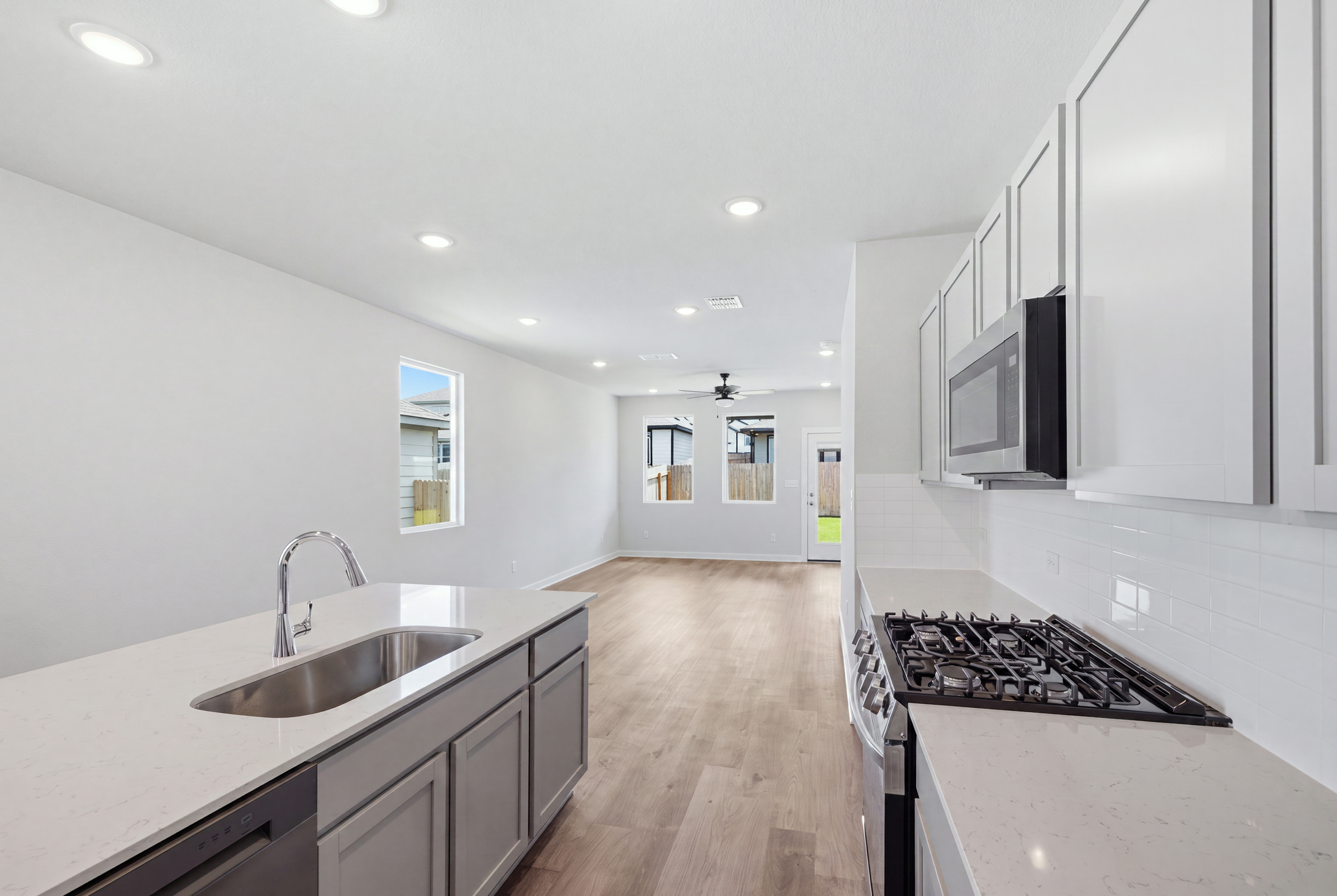 A kitchen with white cabinets.