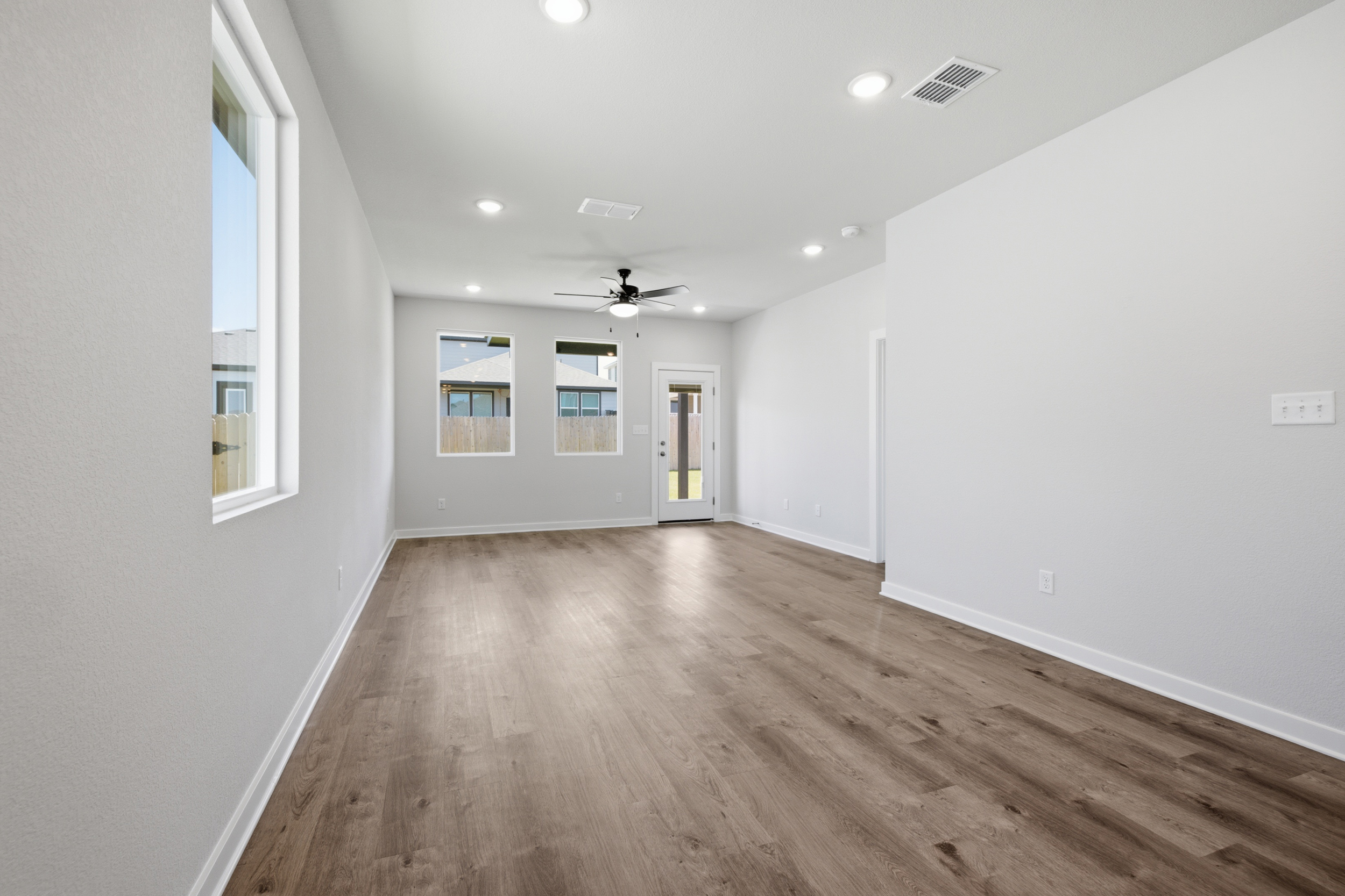 A room with a wood floor and white walls.