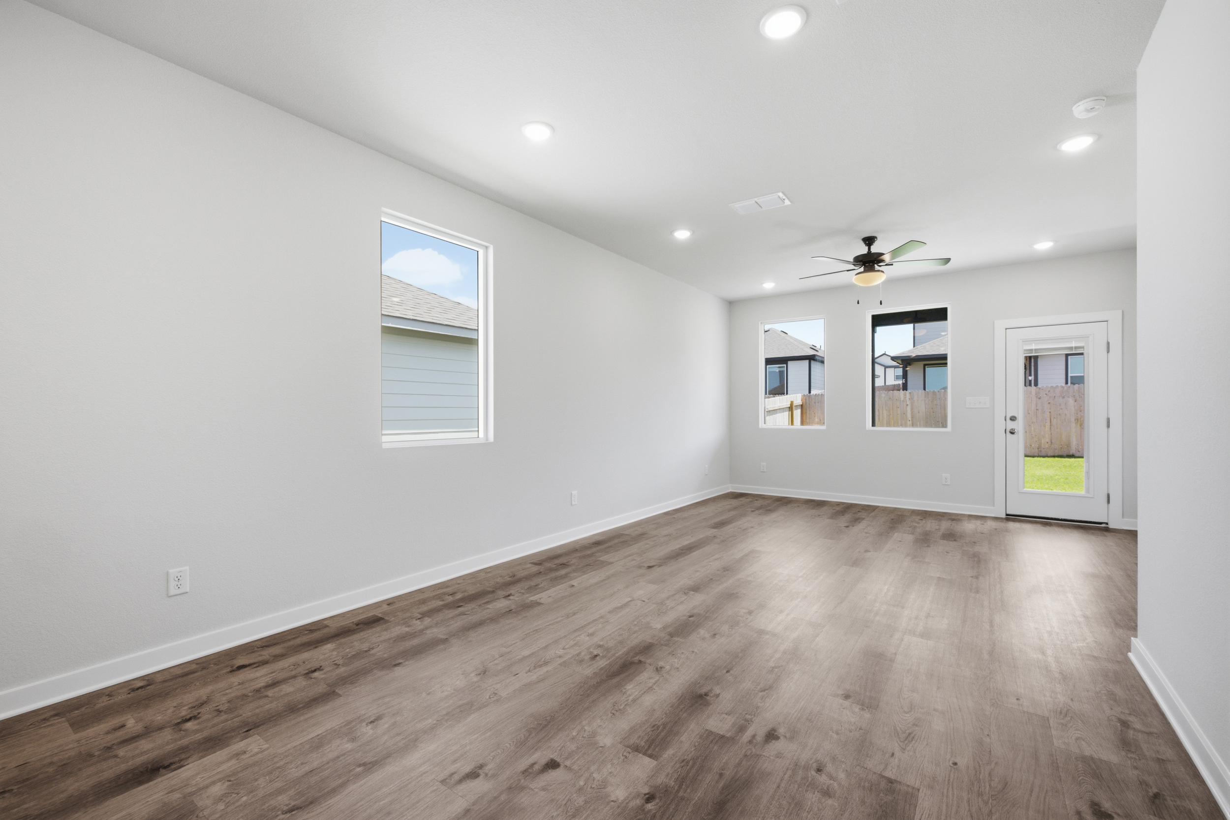 A room with a wood floor and white walls.