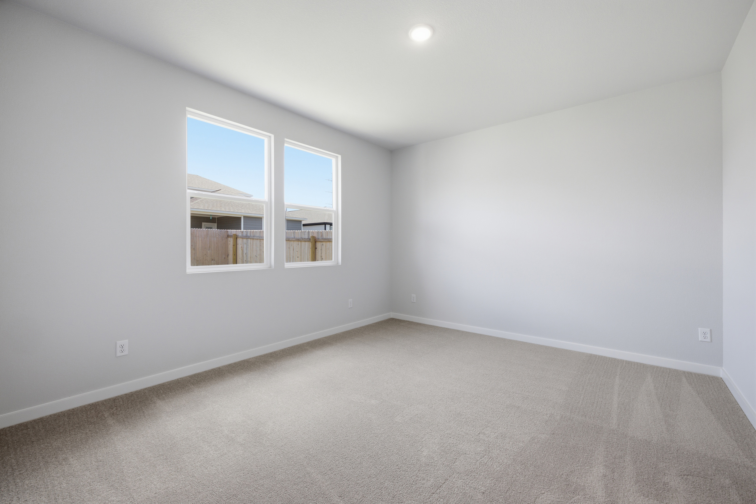 A room with a window and a carpet.