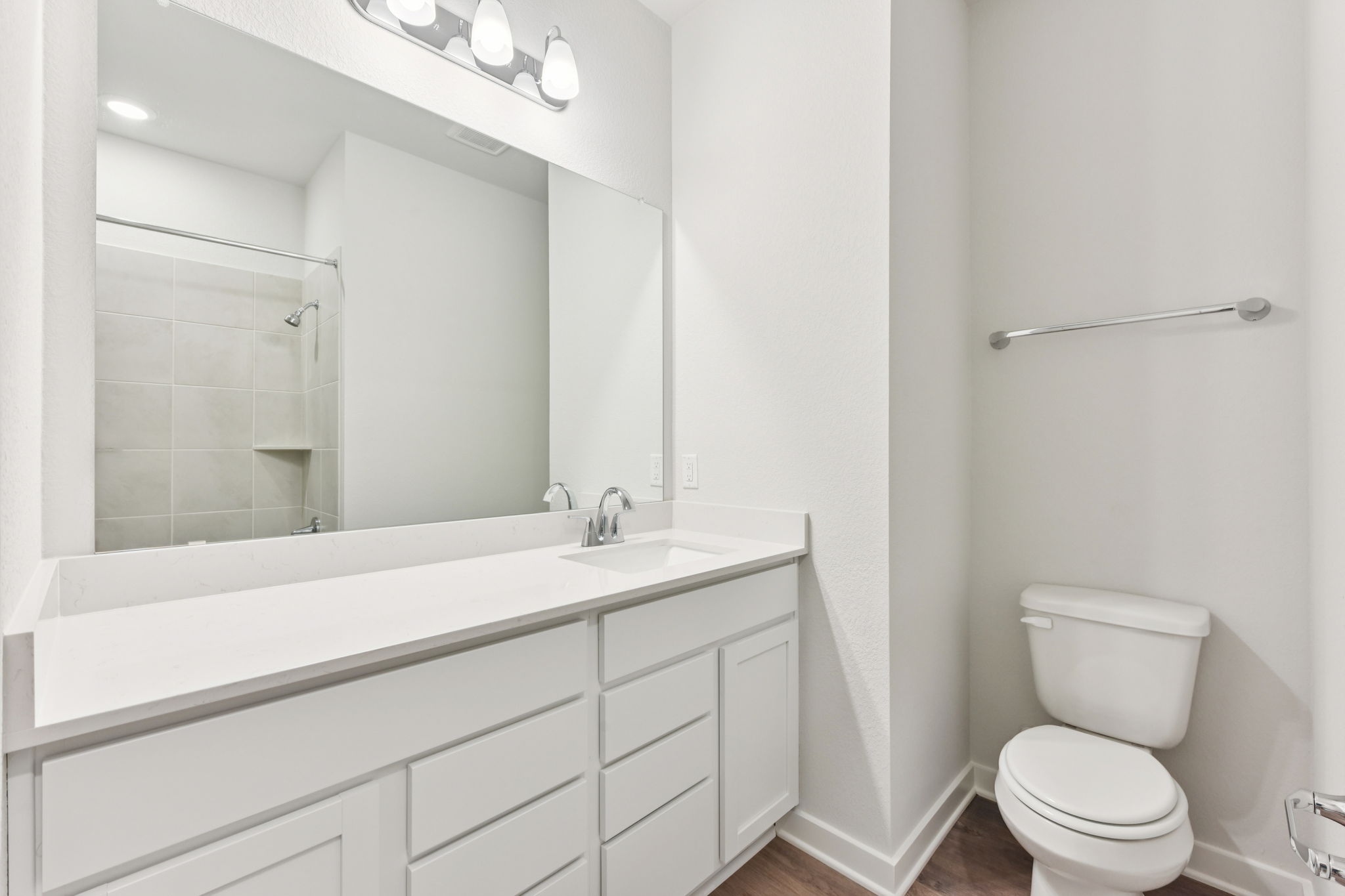A bathroom with a large mirror.