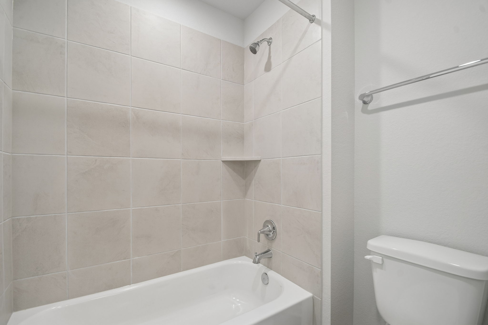 A bathroom with a bathtub and toilet.