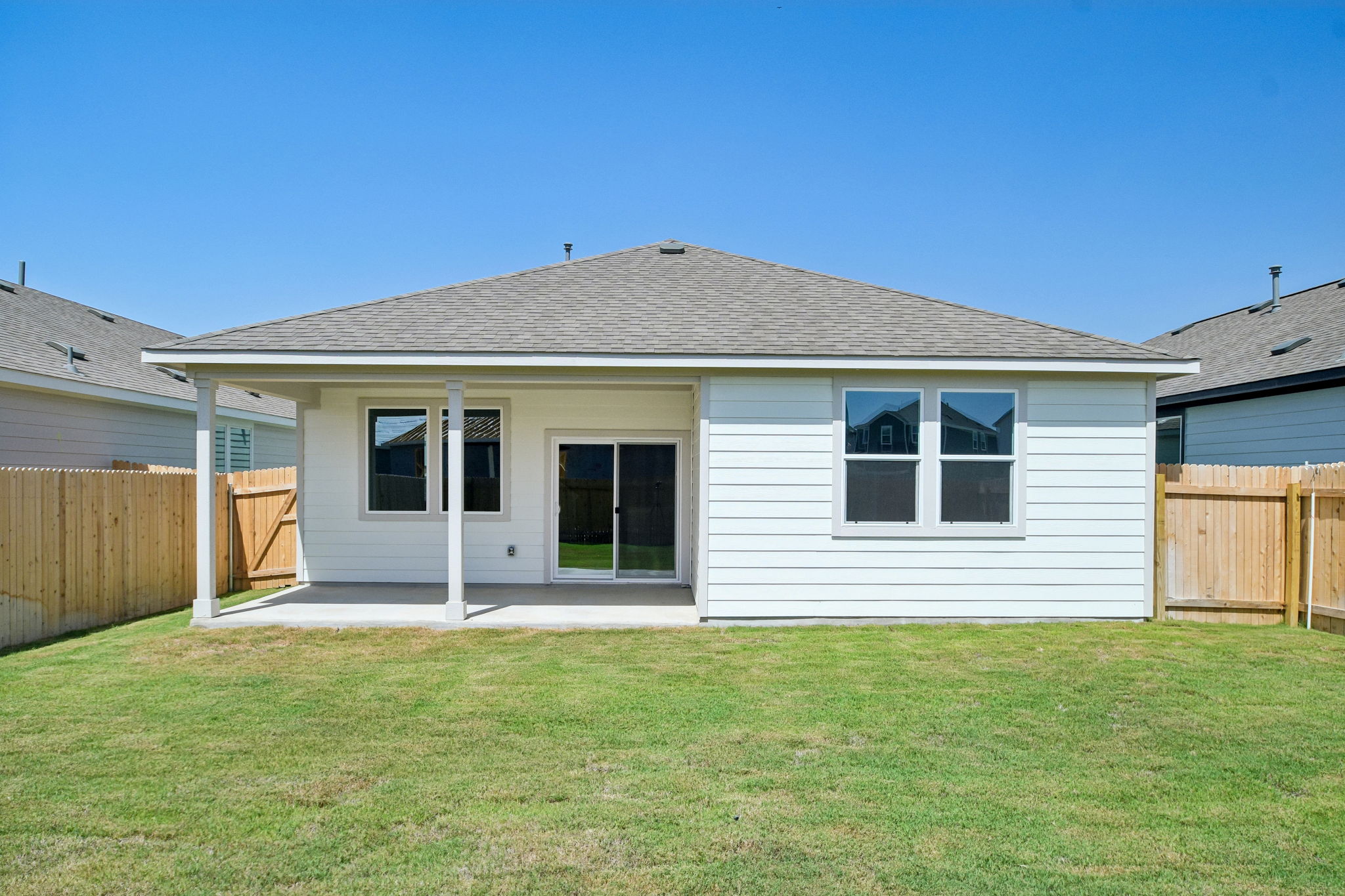 A house with a fence and grass.