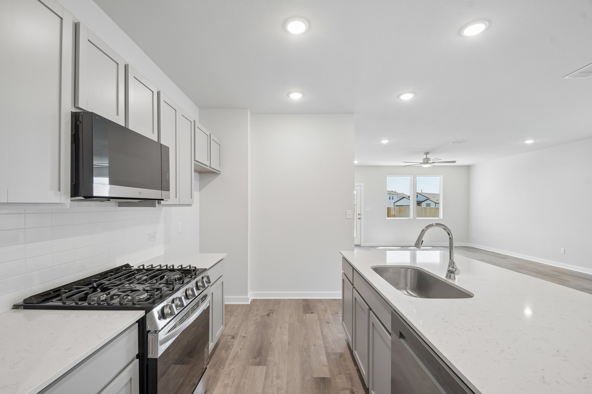A kitchen with white cabinets.