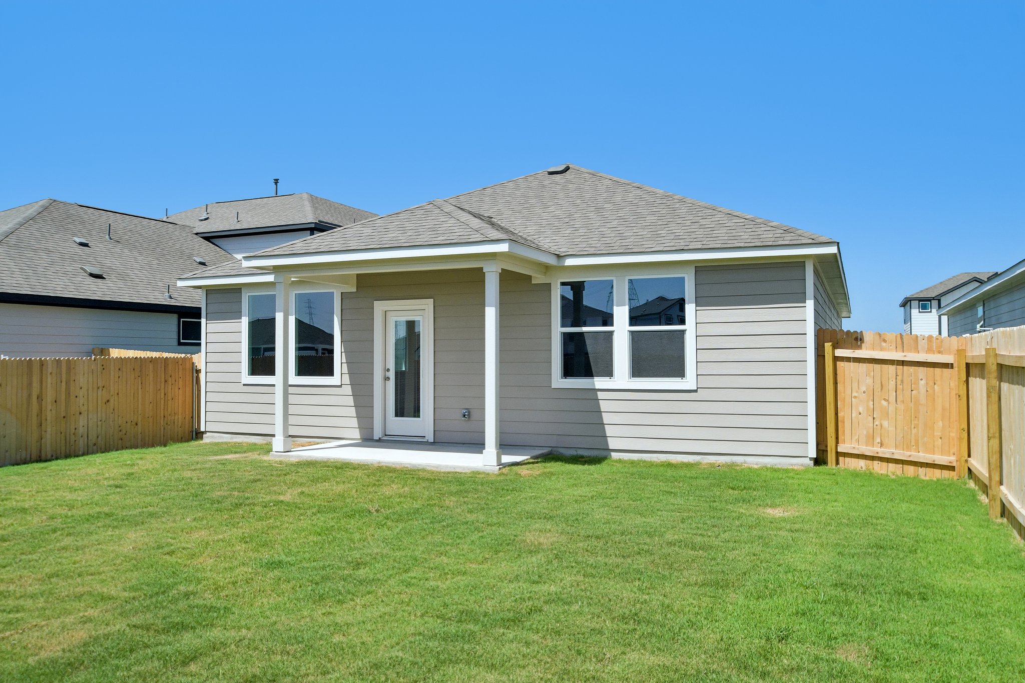 A house with a fence and grass.