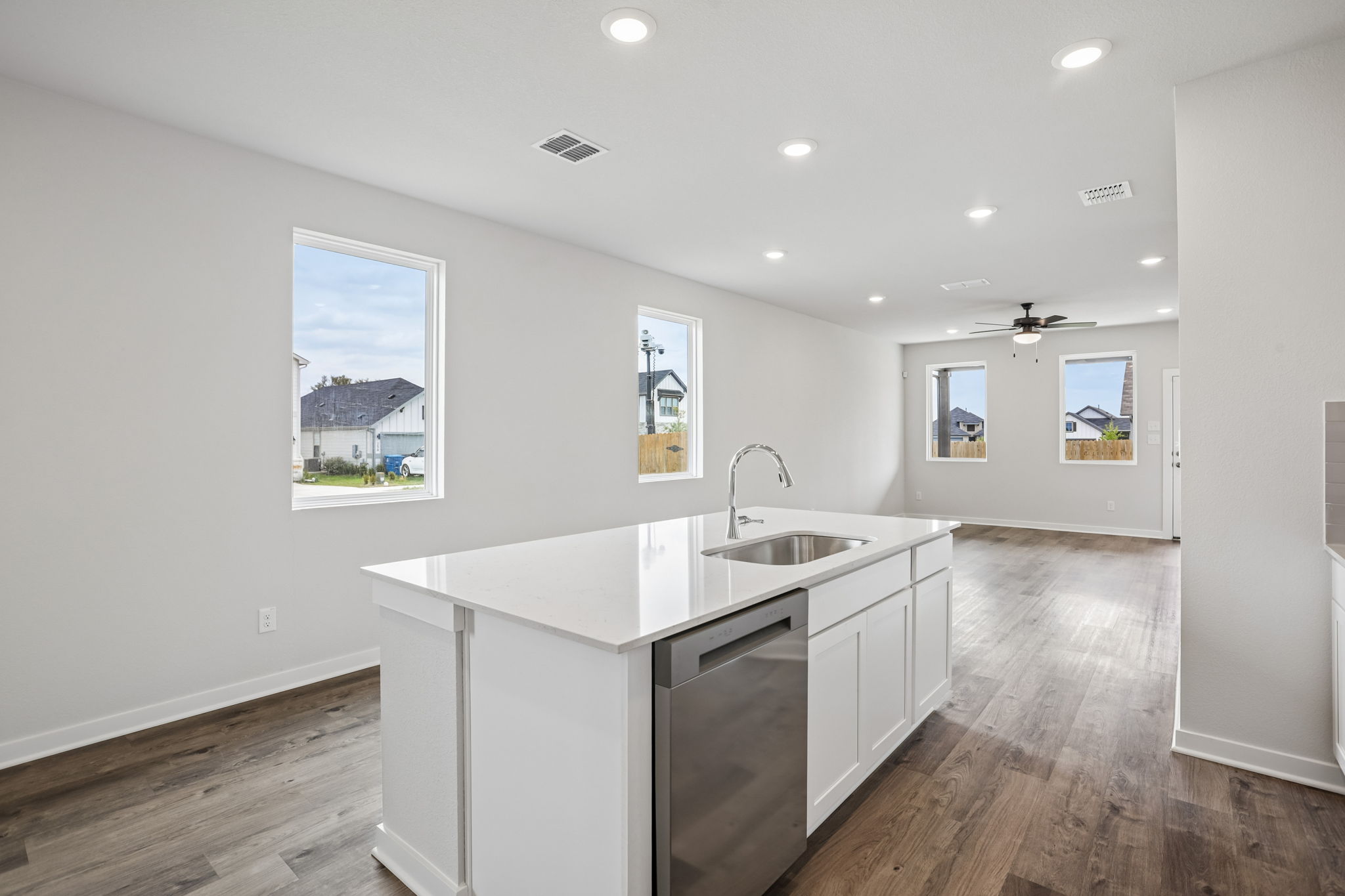 A kitchen with white cabinets.