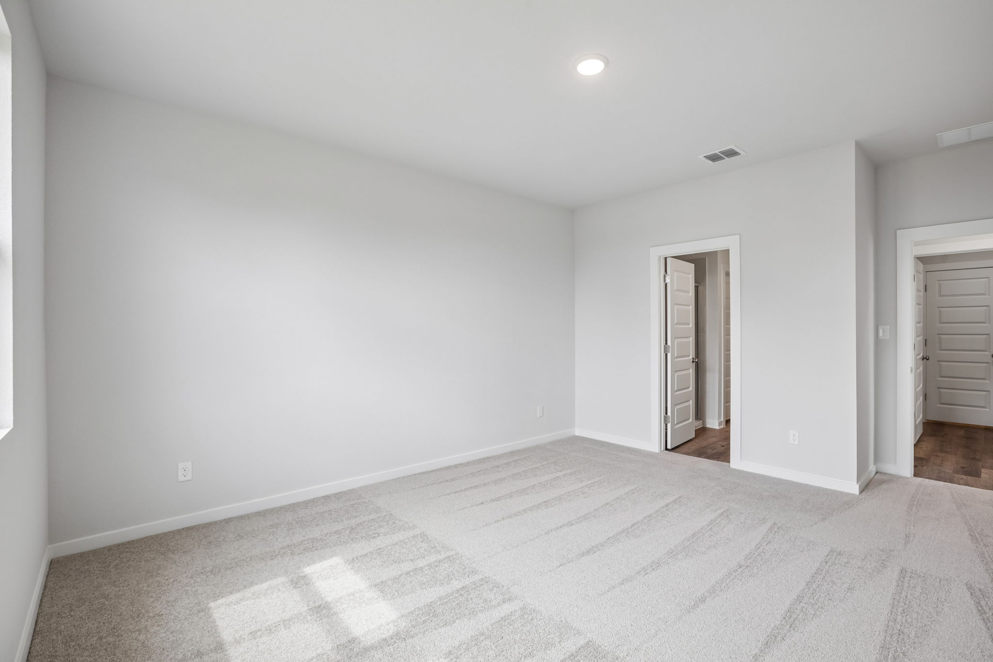 A room with a carpet and a rug.