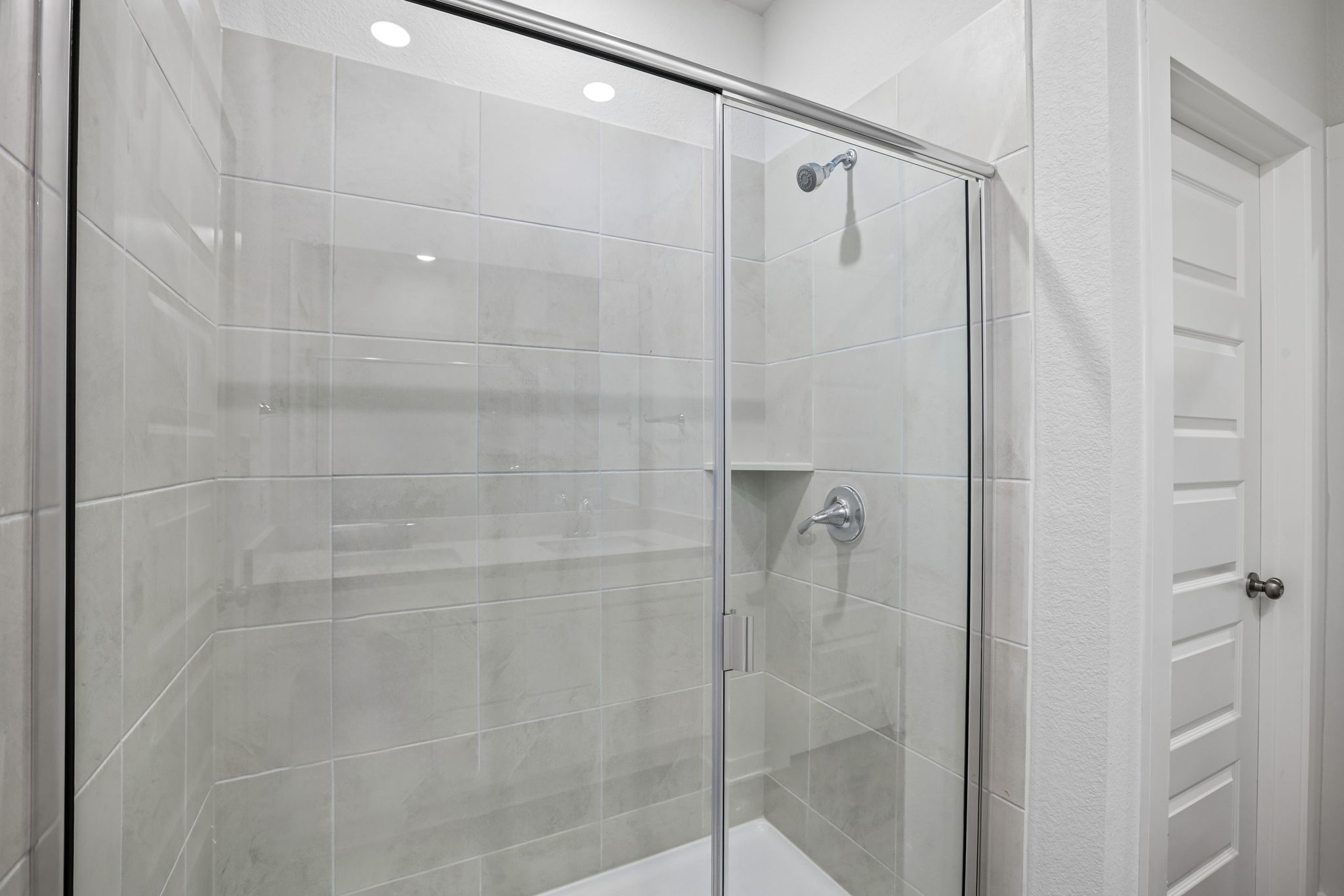 A shower with glass doors.