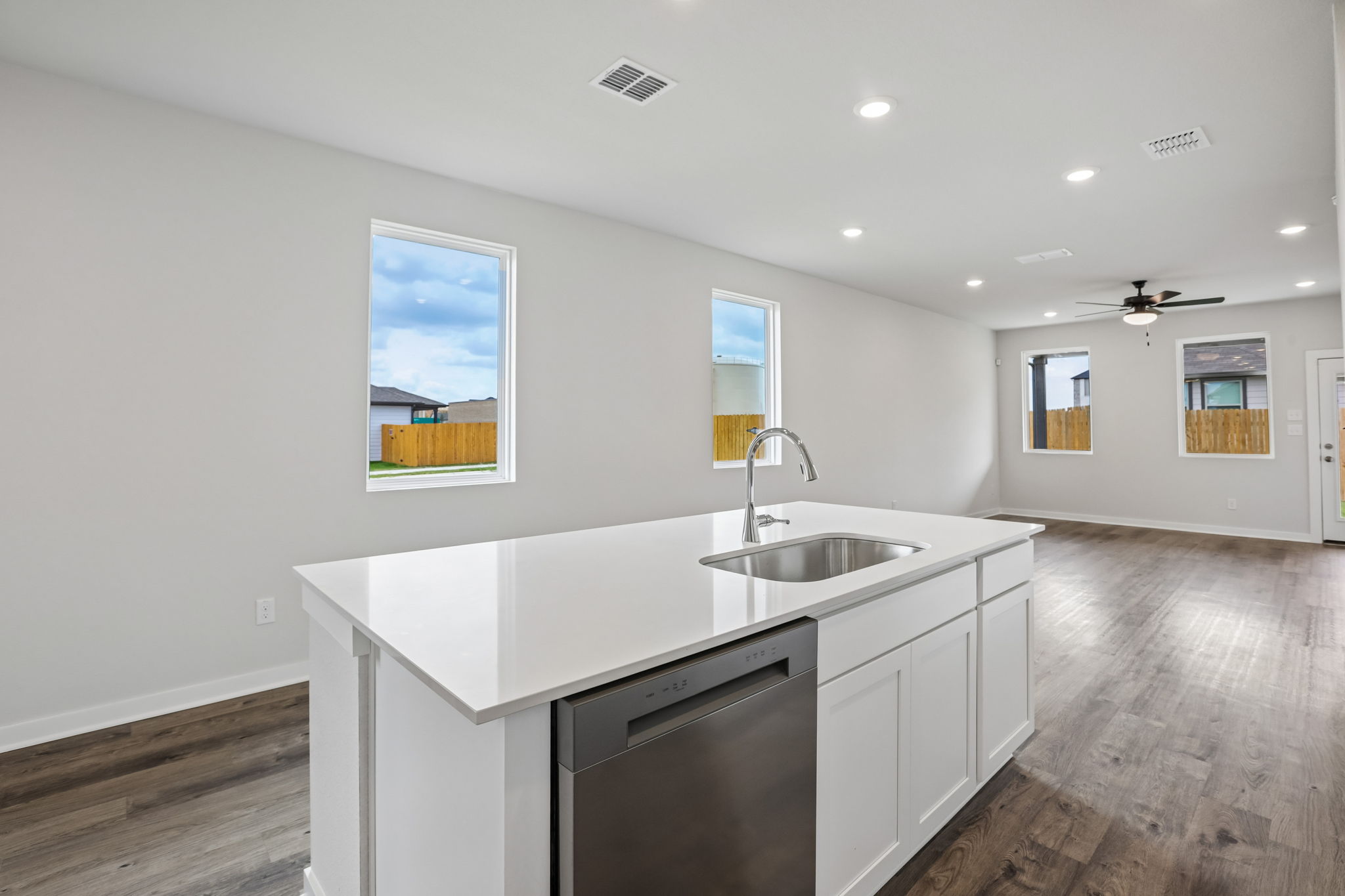 A kitchen with white cabinets.
