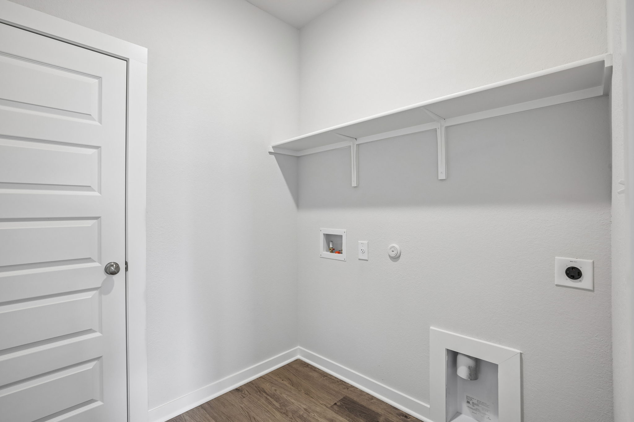 A white wall with a white door.