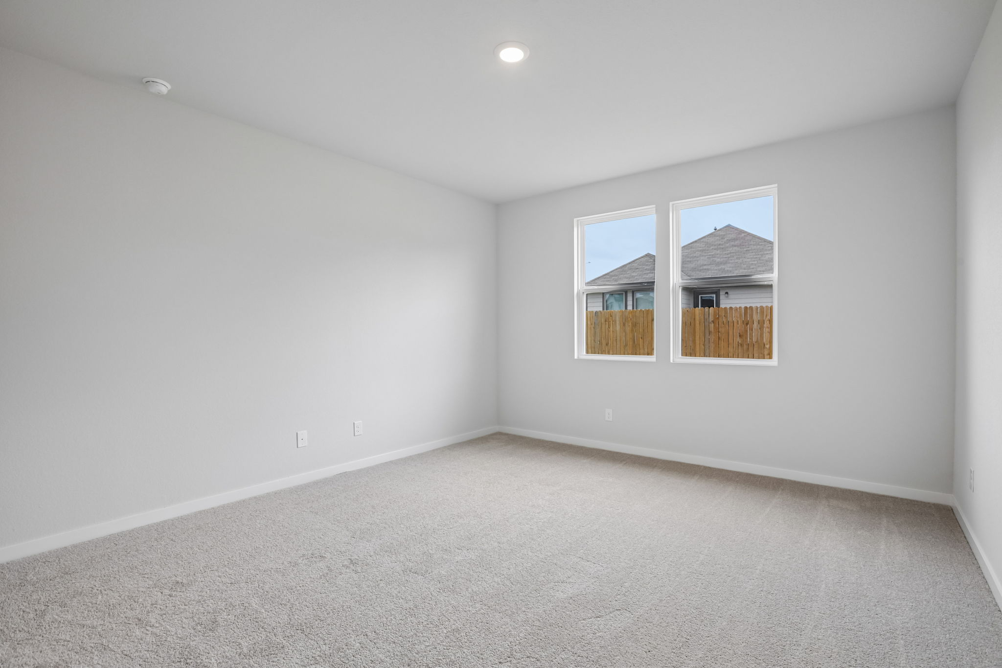 A room with a window and a carpet.