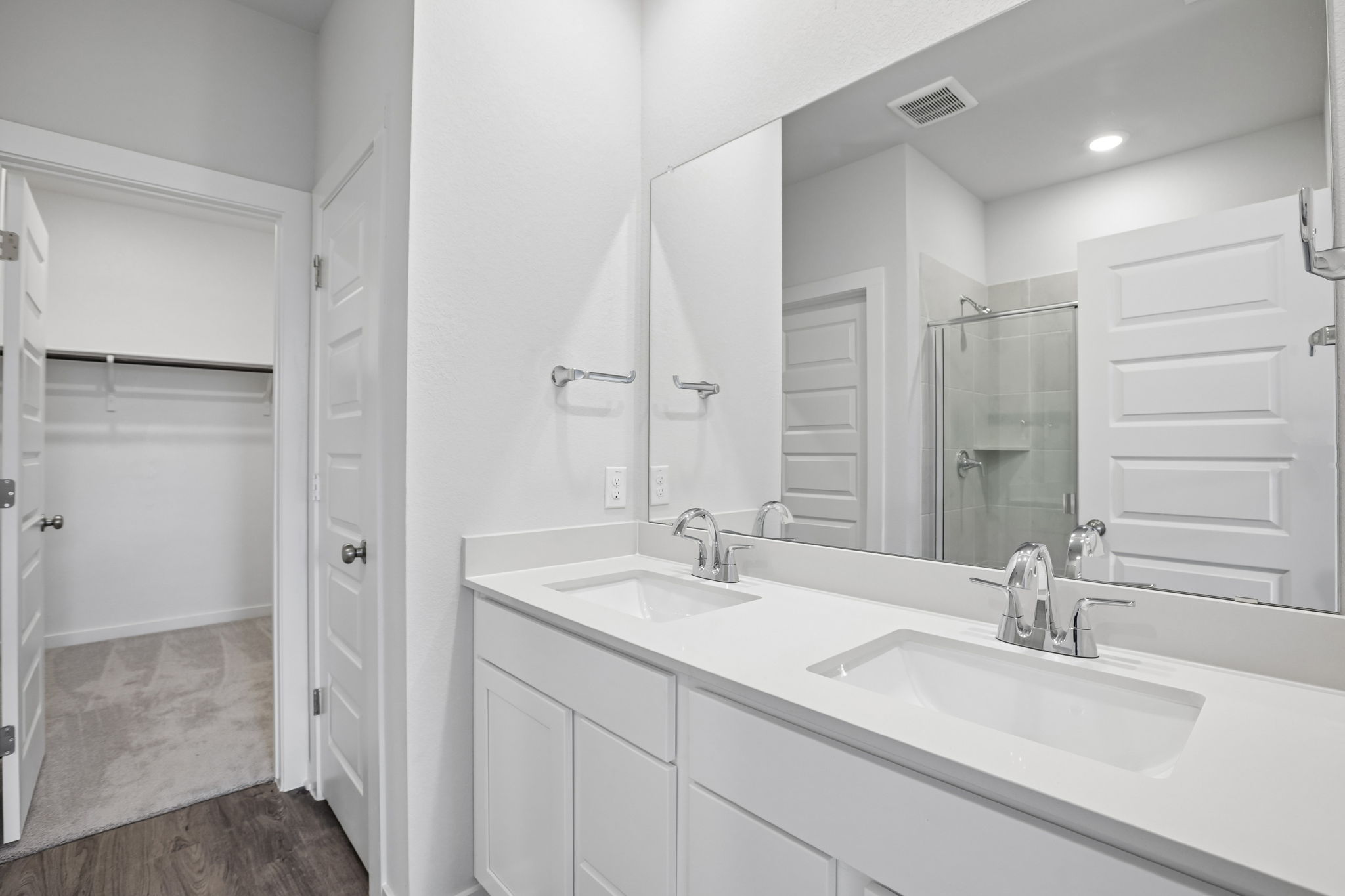 A bathroom with a large mirror.