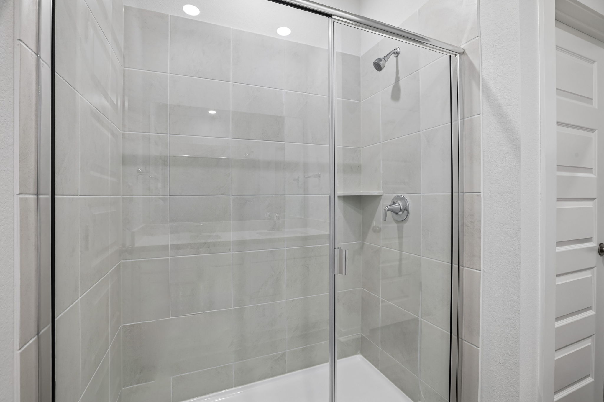 A shower with a glass door.