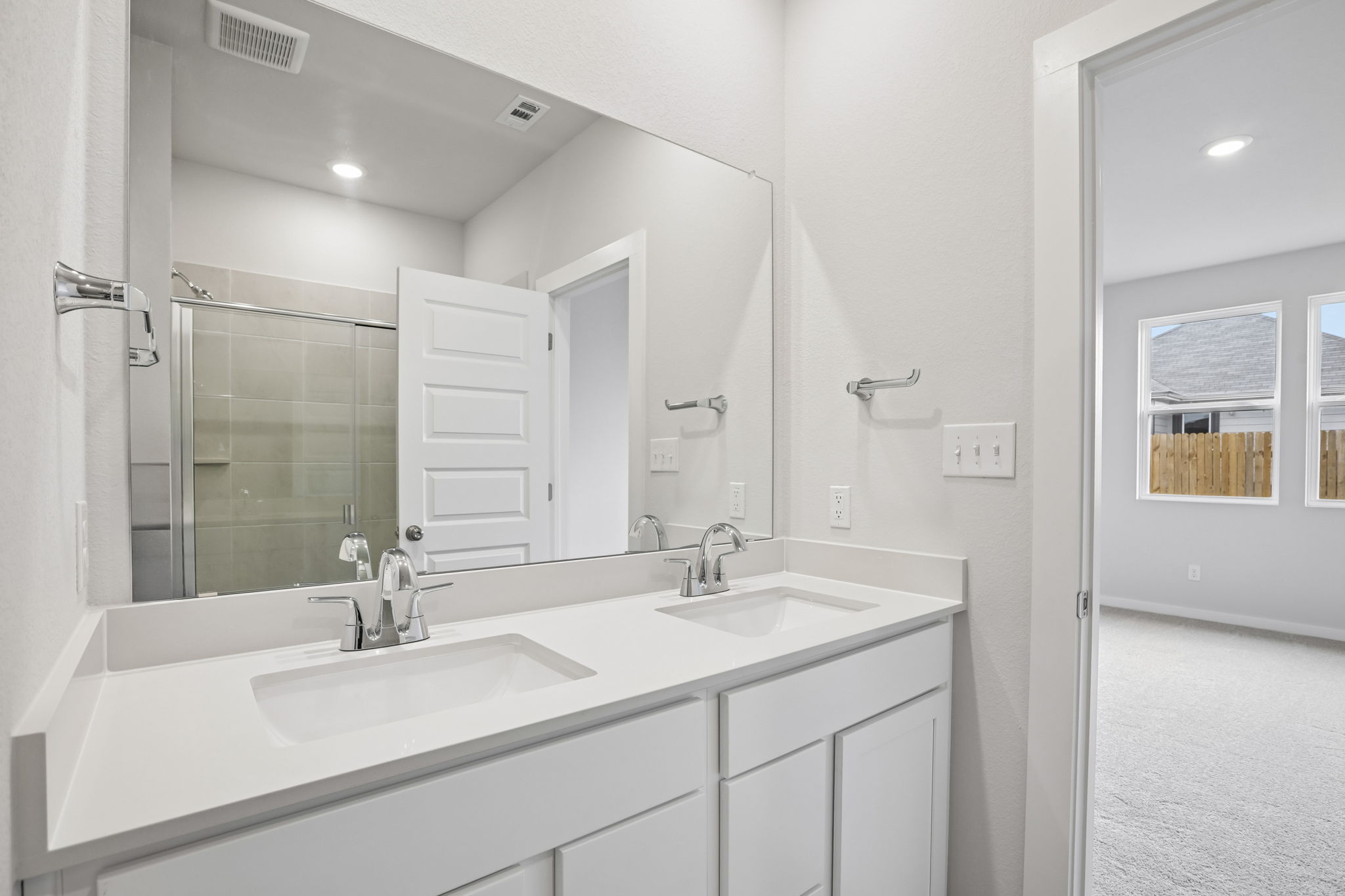 A bathroom with a large mirror.
