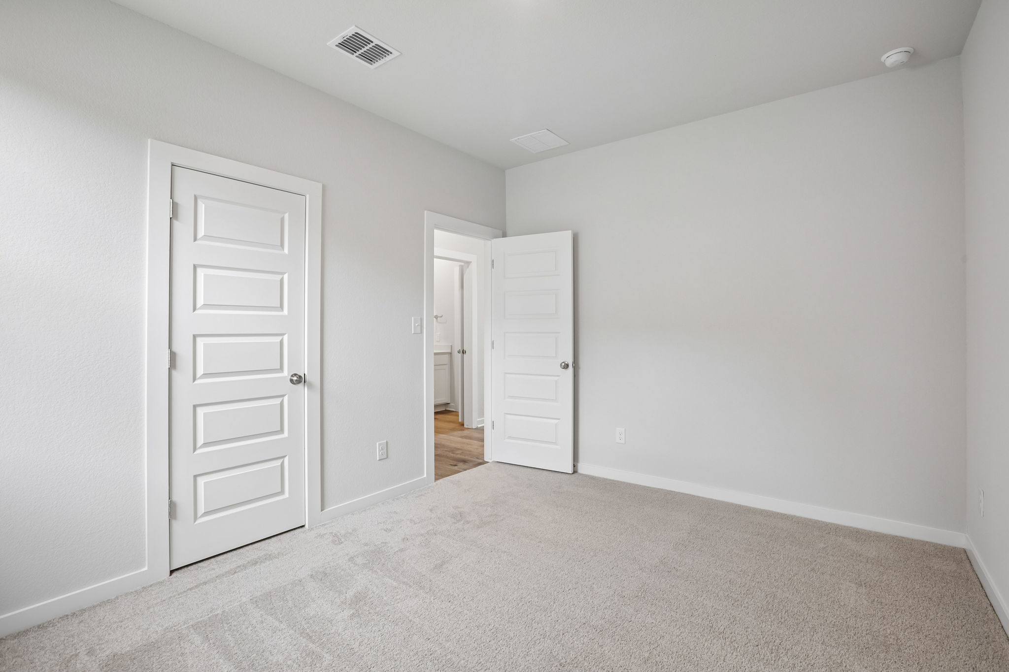 A hallway with white doors.