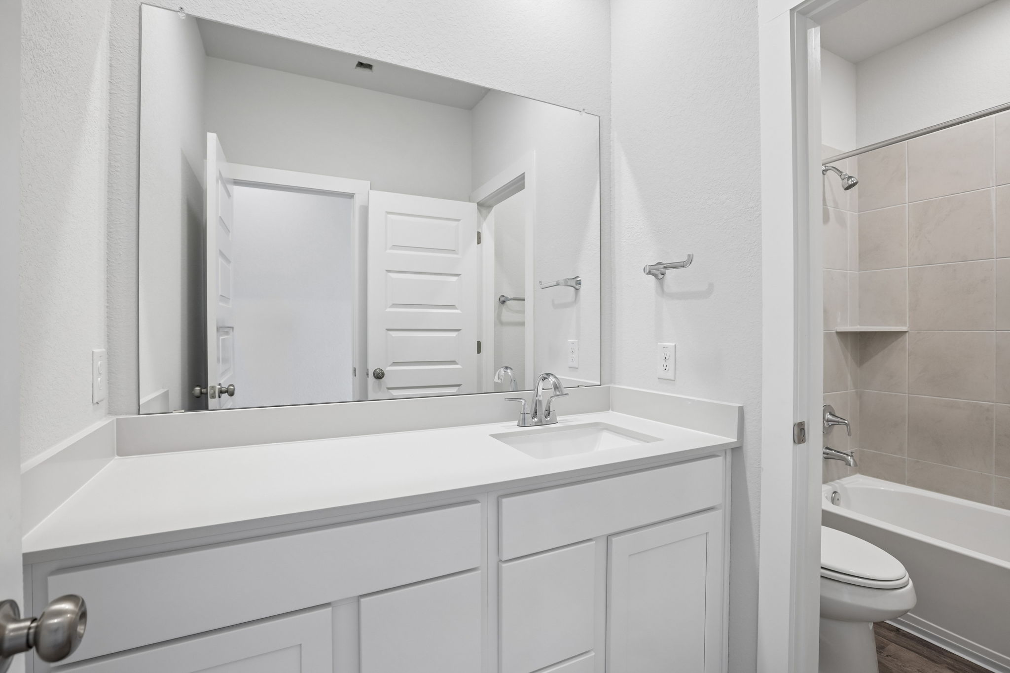 A bathroom with a sink and toilet.