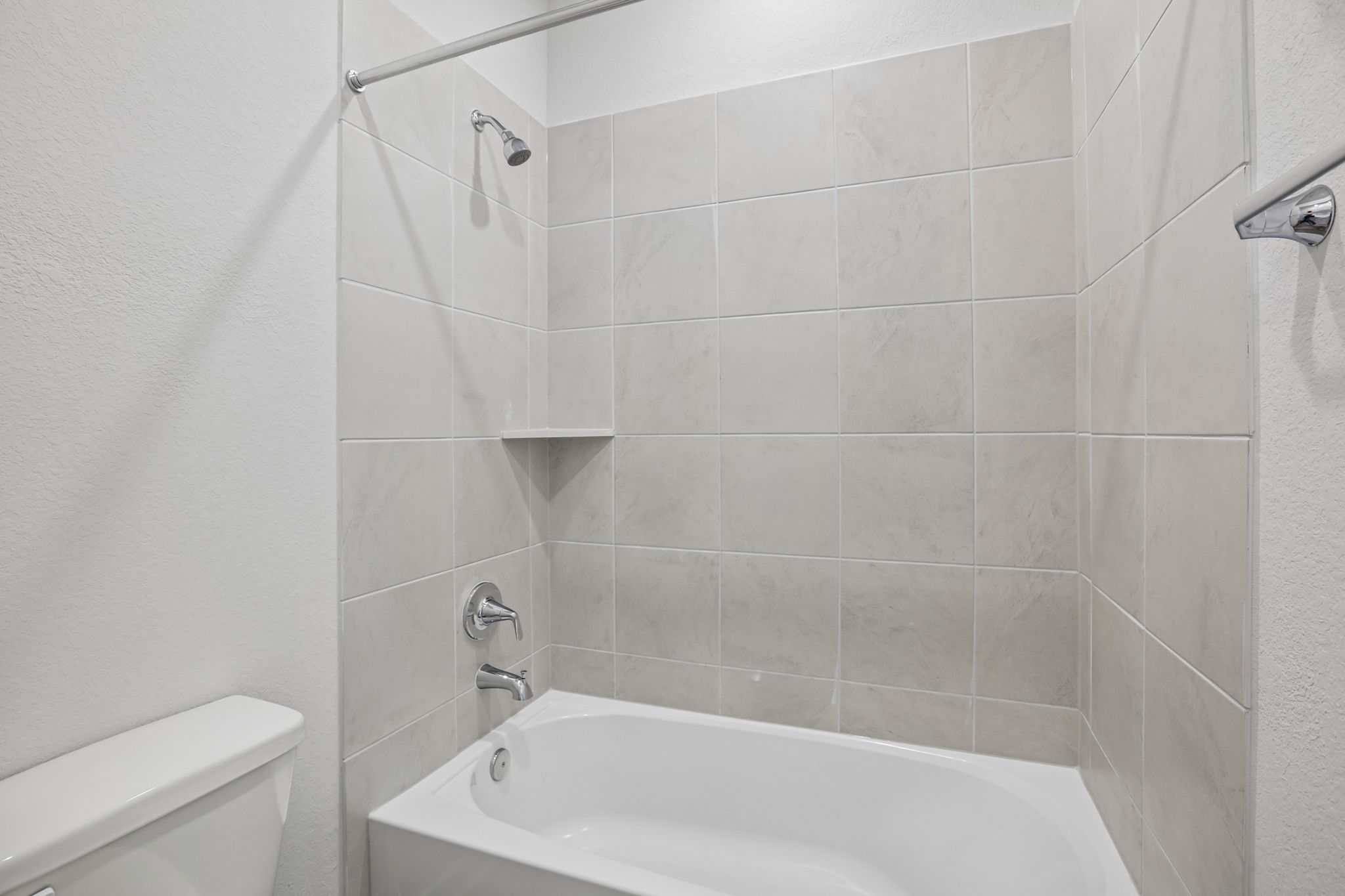A bathtub in a bathroom.