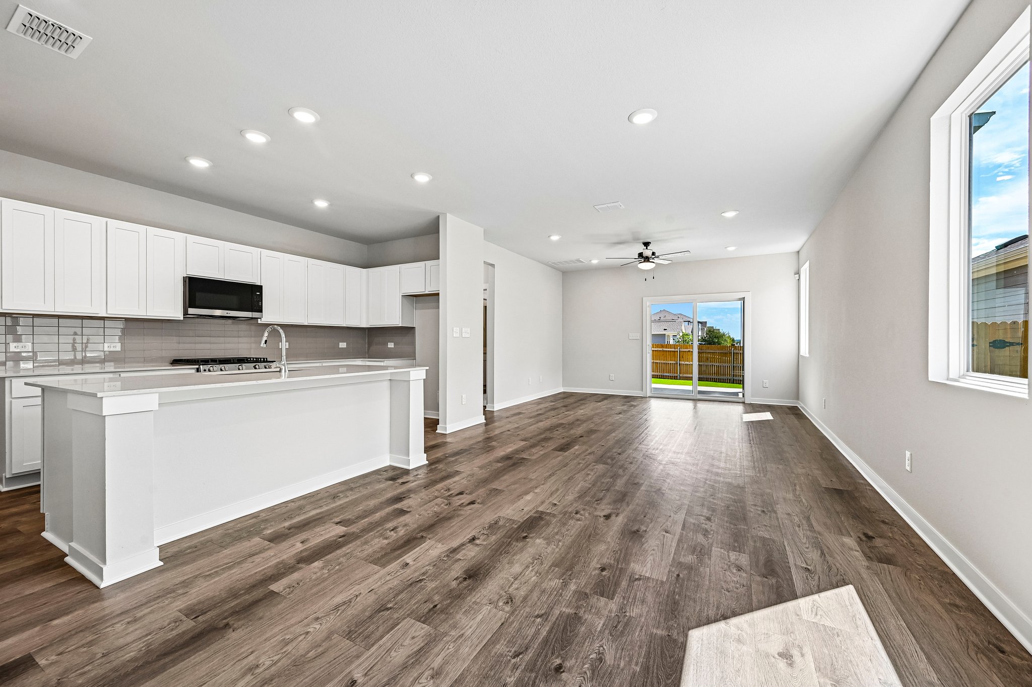 A kitchen with white cabinets.
