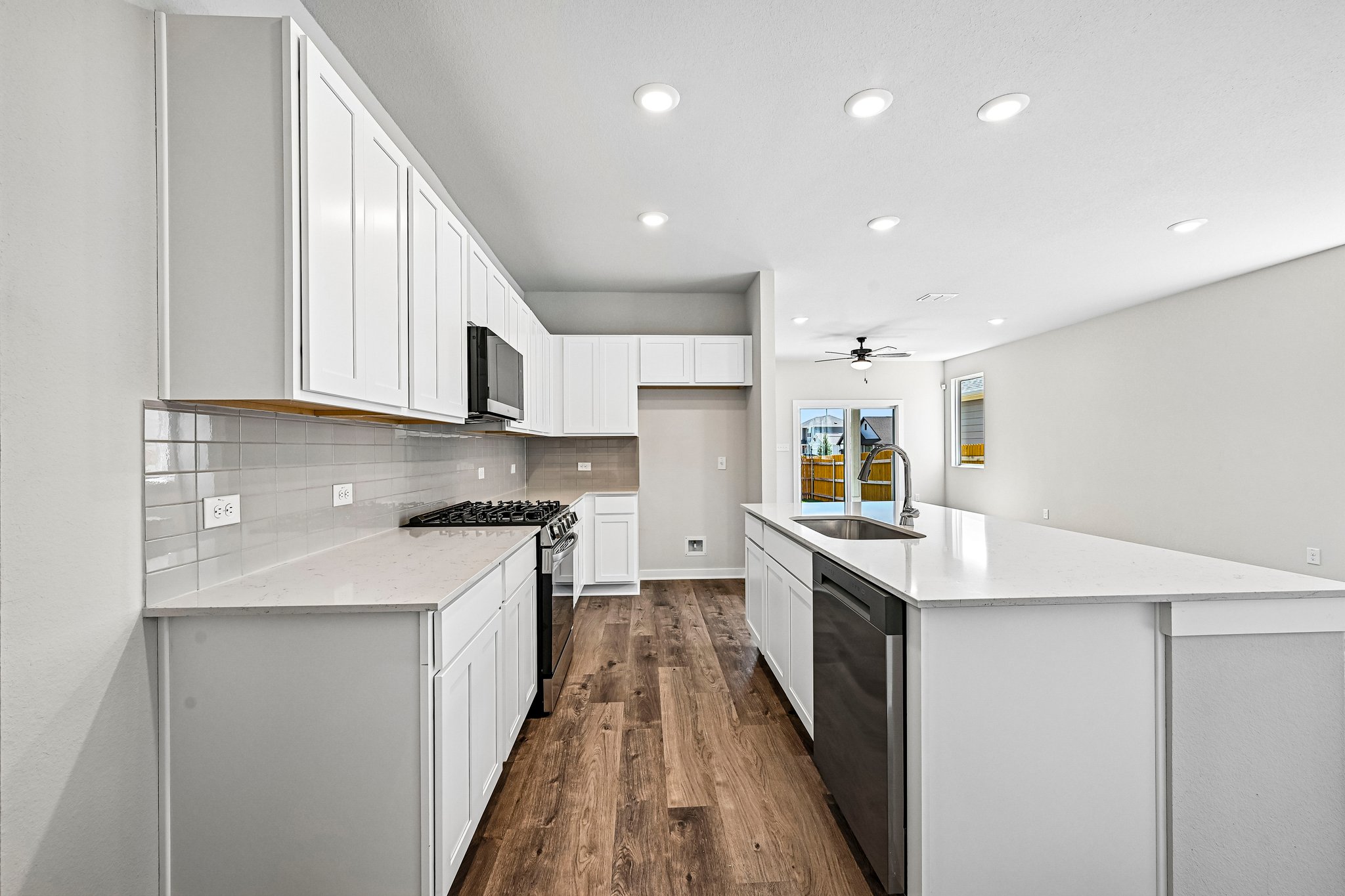 A kitchen with white cabinets.