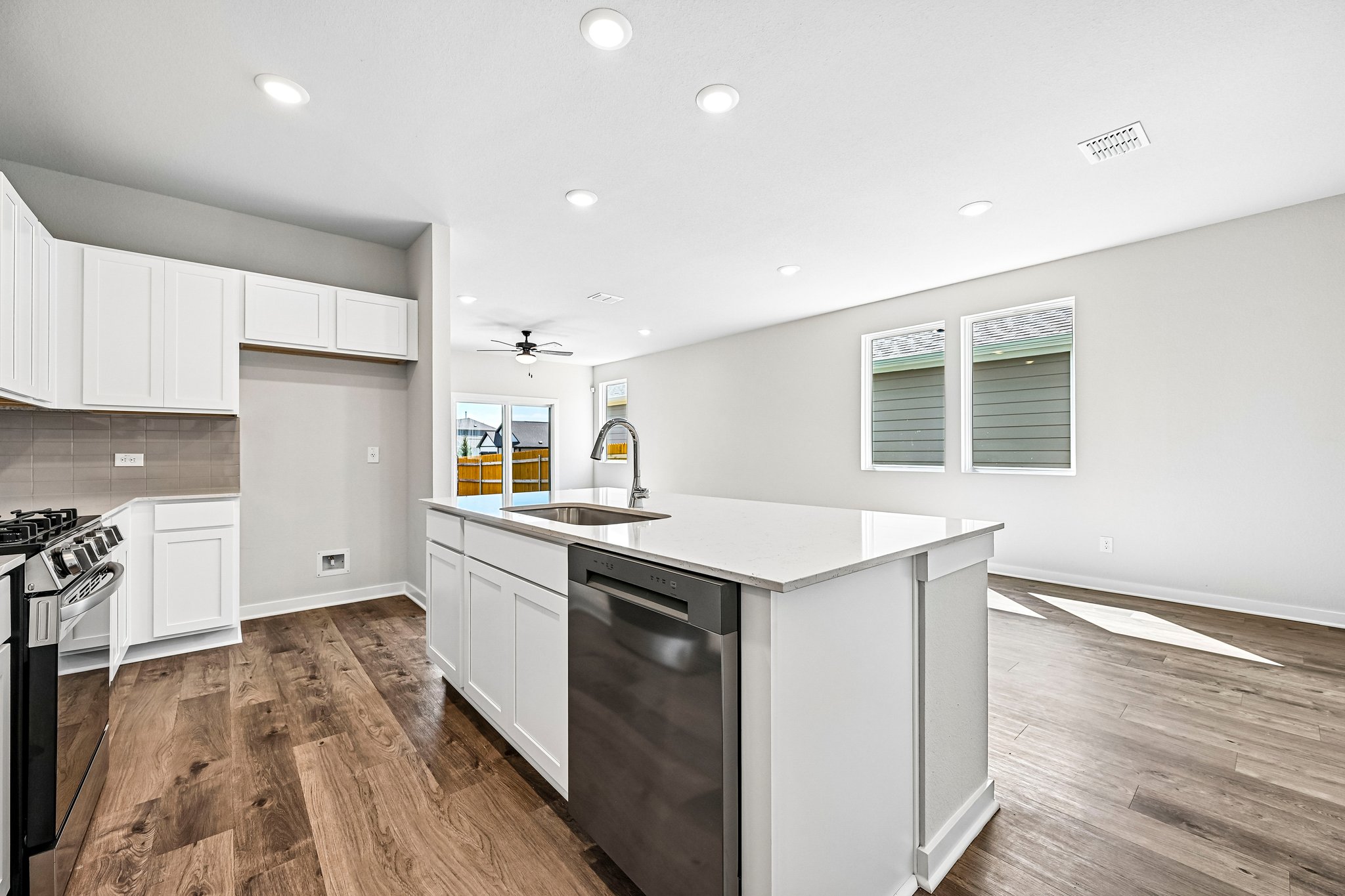 A kitchen with white cabinets.