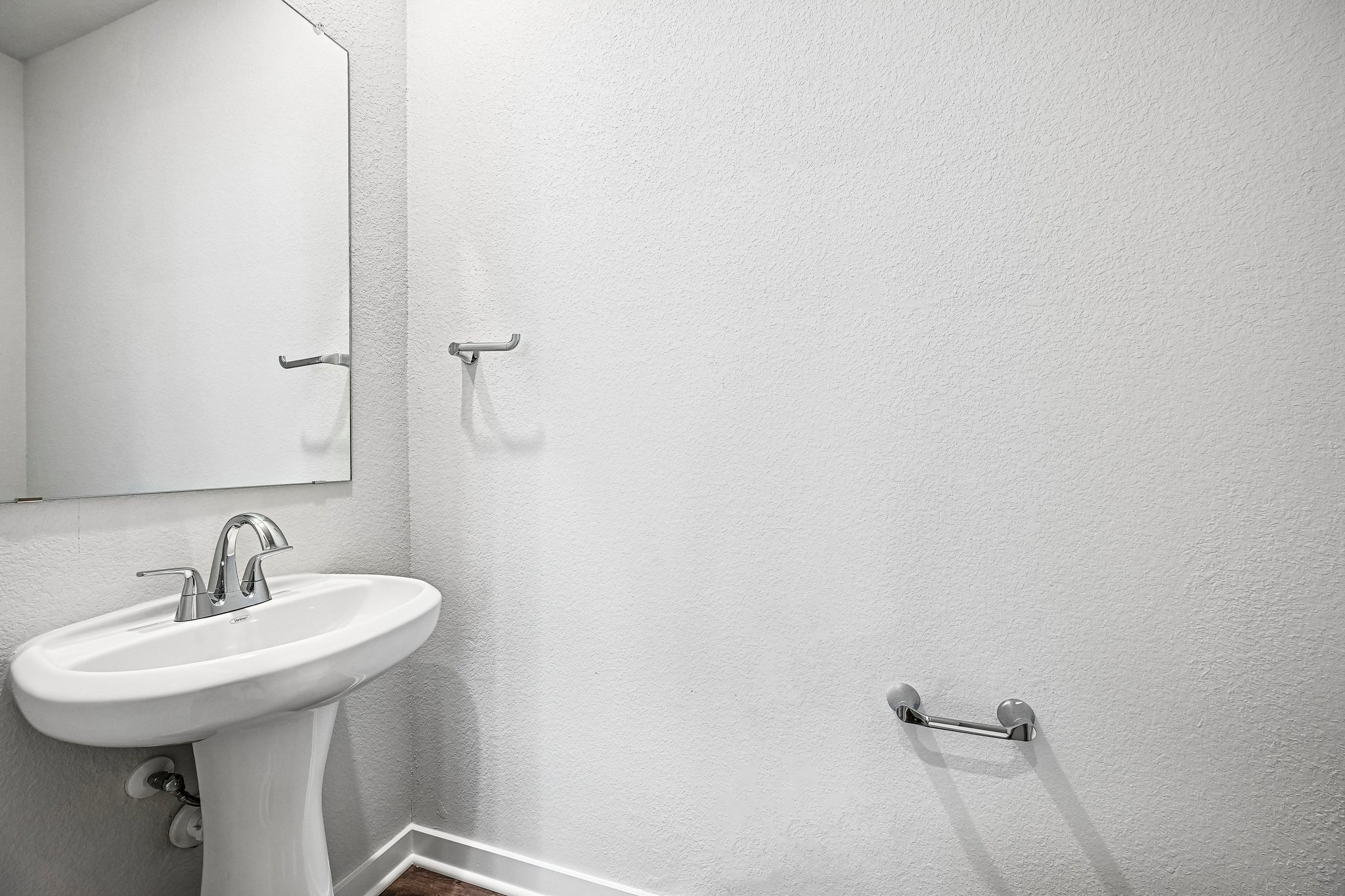 A bathroom with a mirror and sink.