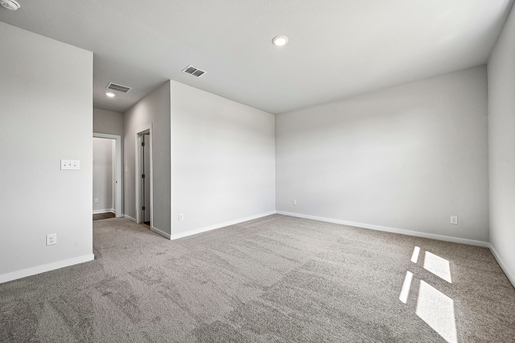 A hallway with carpet.