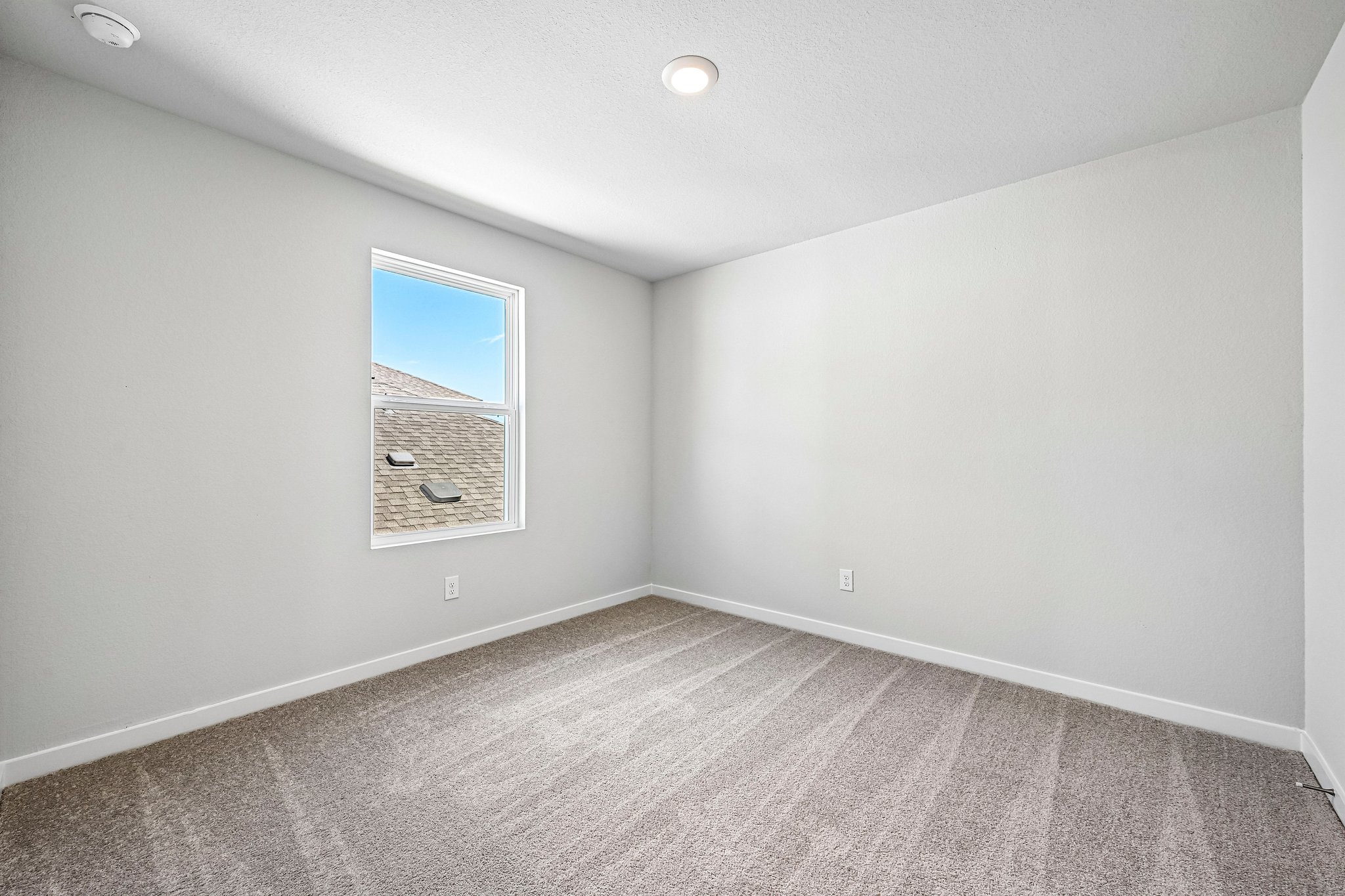 A room with a painting on the wall.