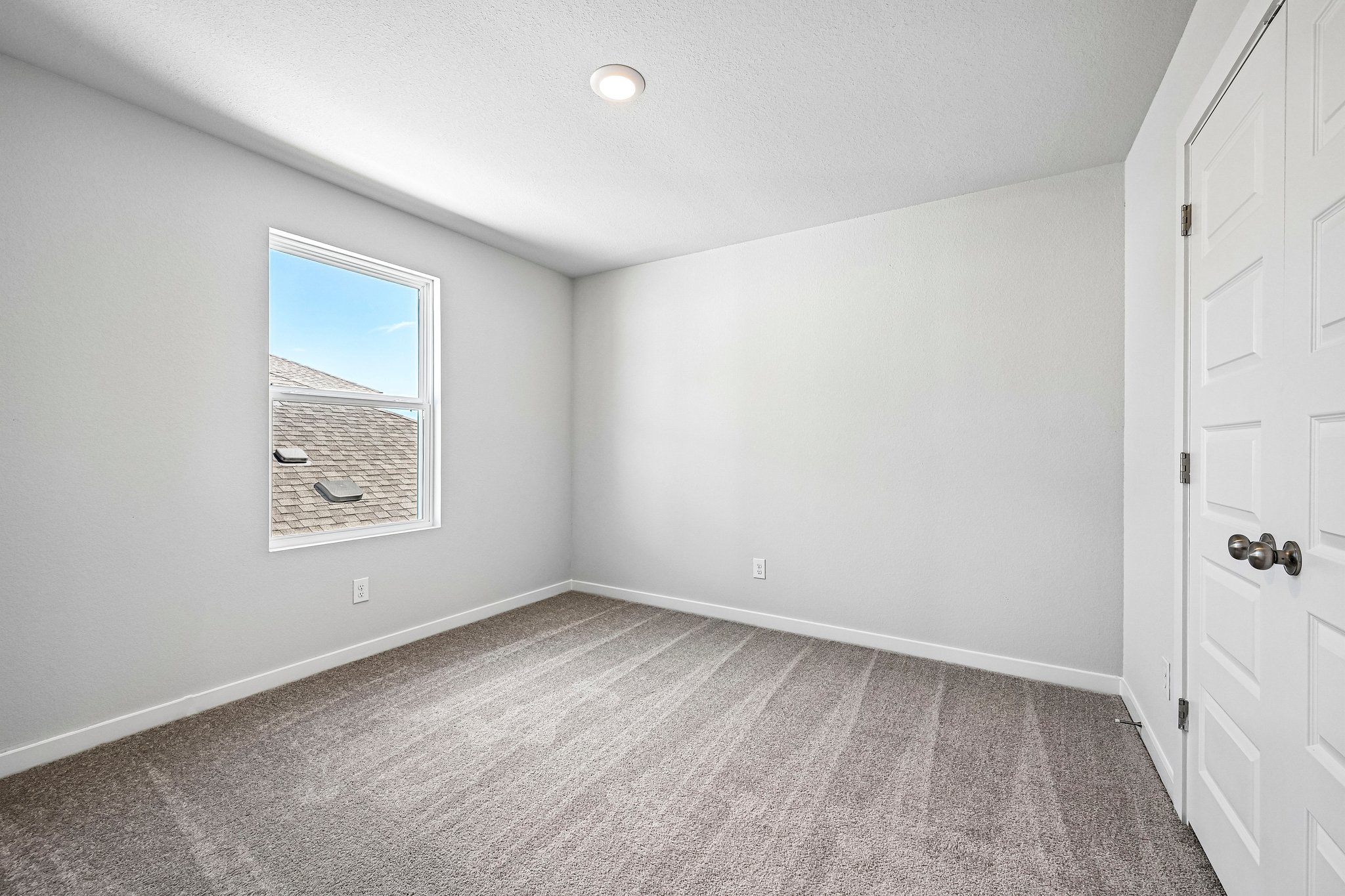 A room with a window and a door.