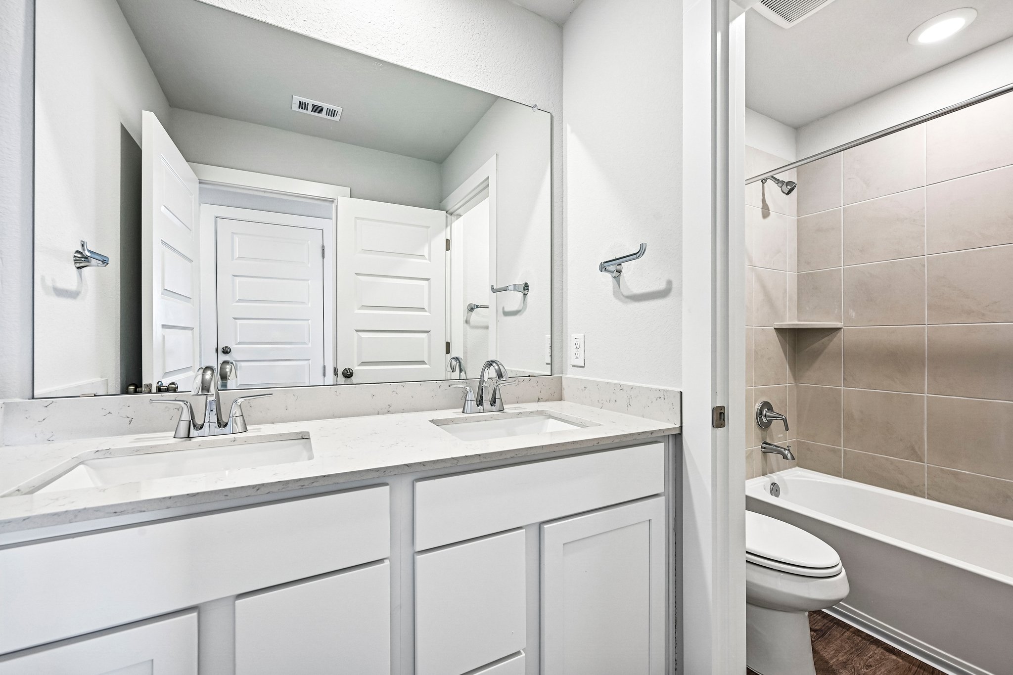 A bathroom with a tub sink and toilet.