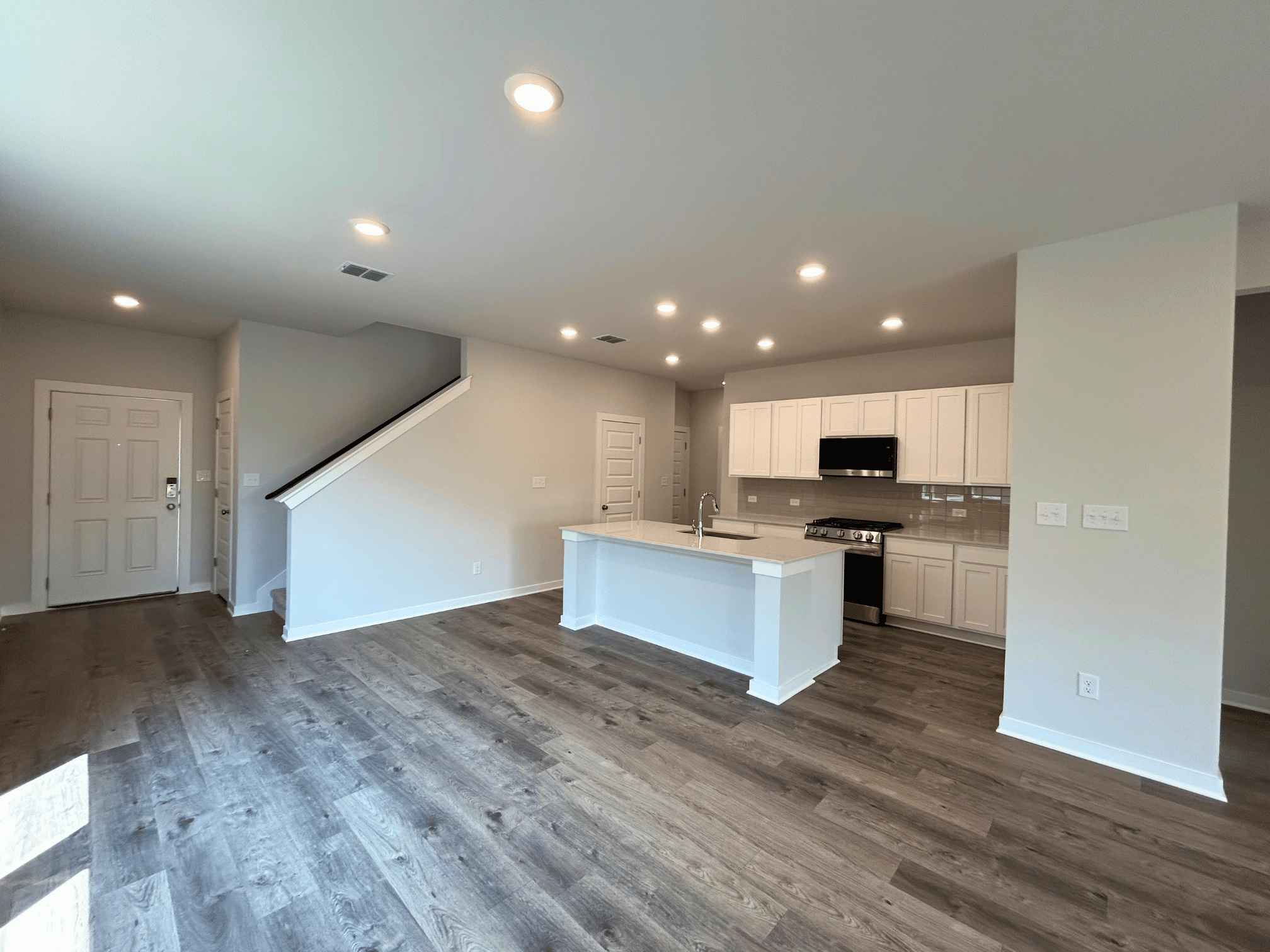 A kitchen with a wood floor.