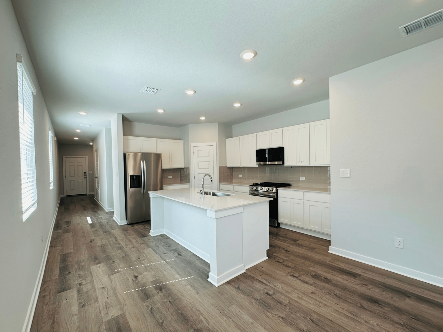 A kitchen with white cabinets.