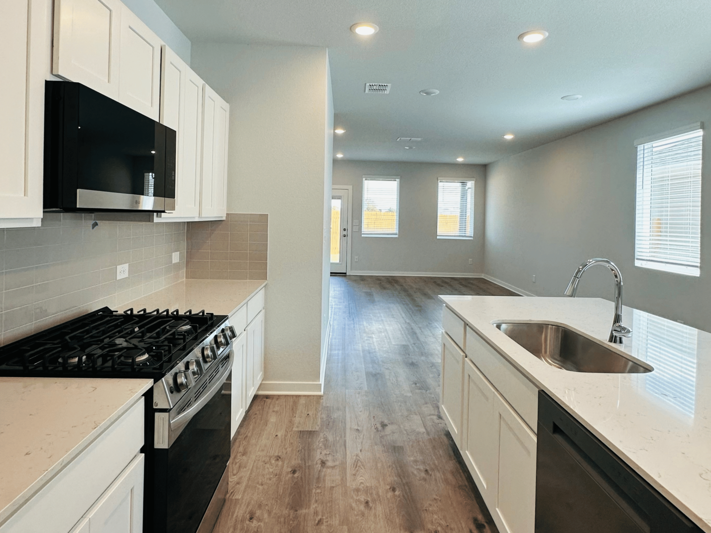 A kitchen with white cabinets.