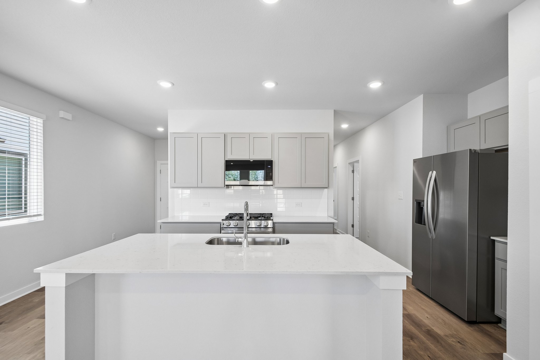 A kitchen with white cabinets.