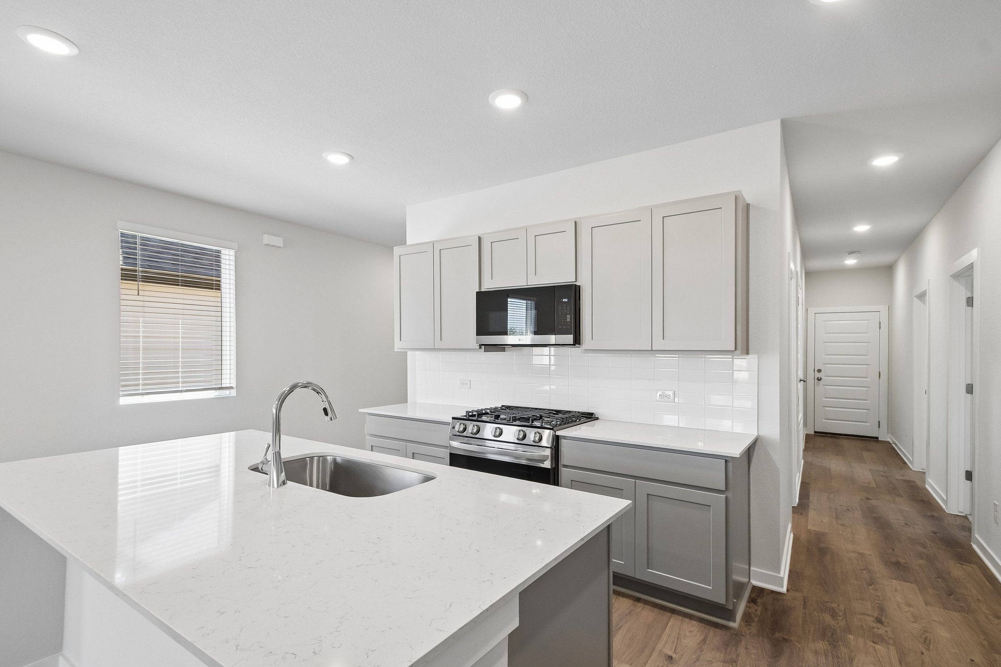 A kitchen with white cabinets.