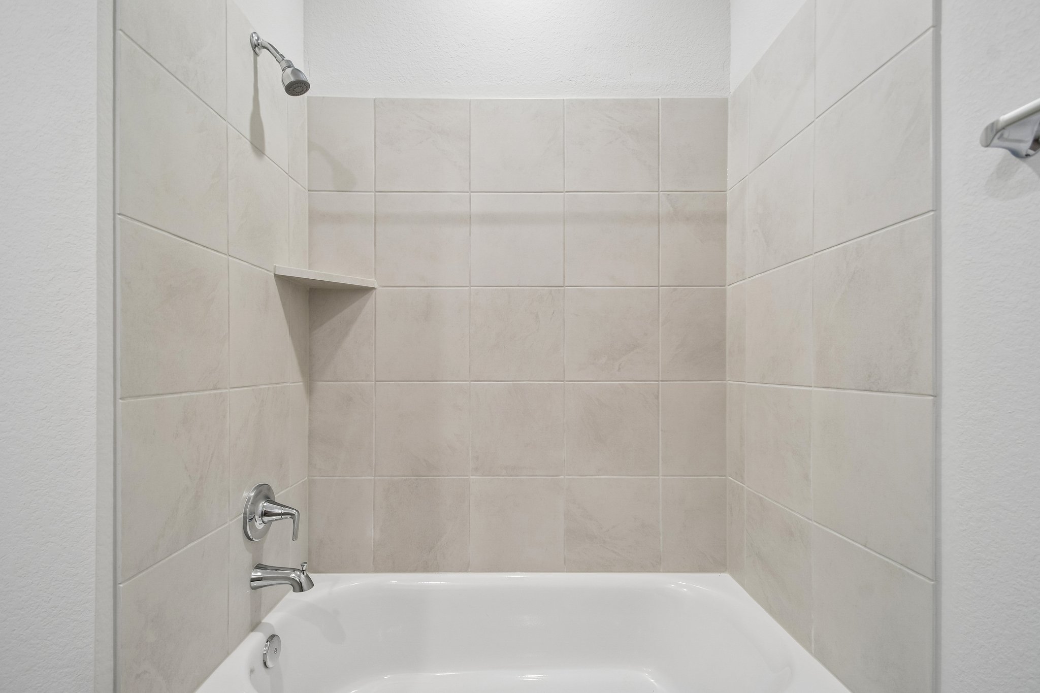 A bathtub in a bathroom.