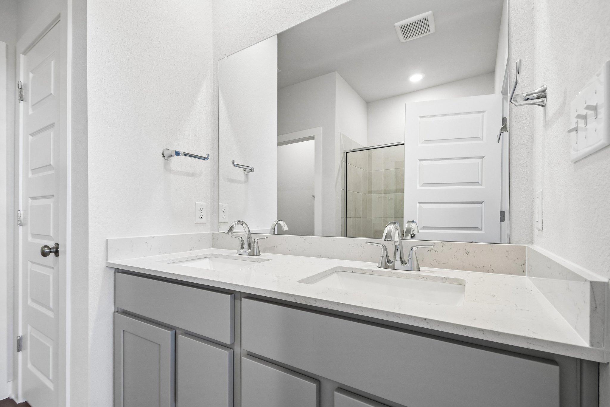 A bathroom with a large mirror.