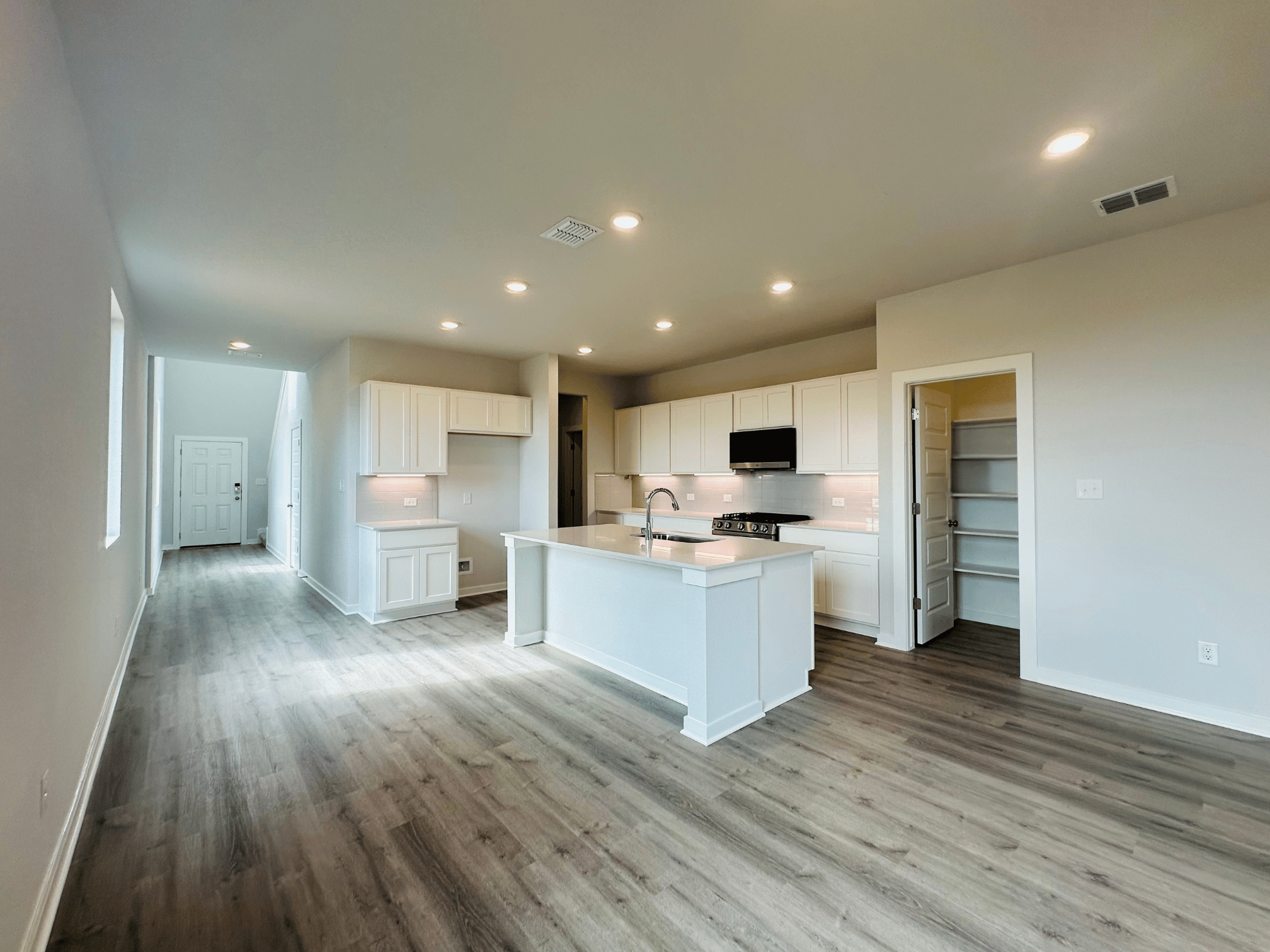 A kitchen with white cabinets.