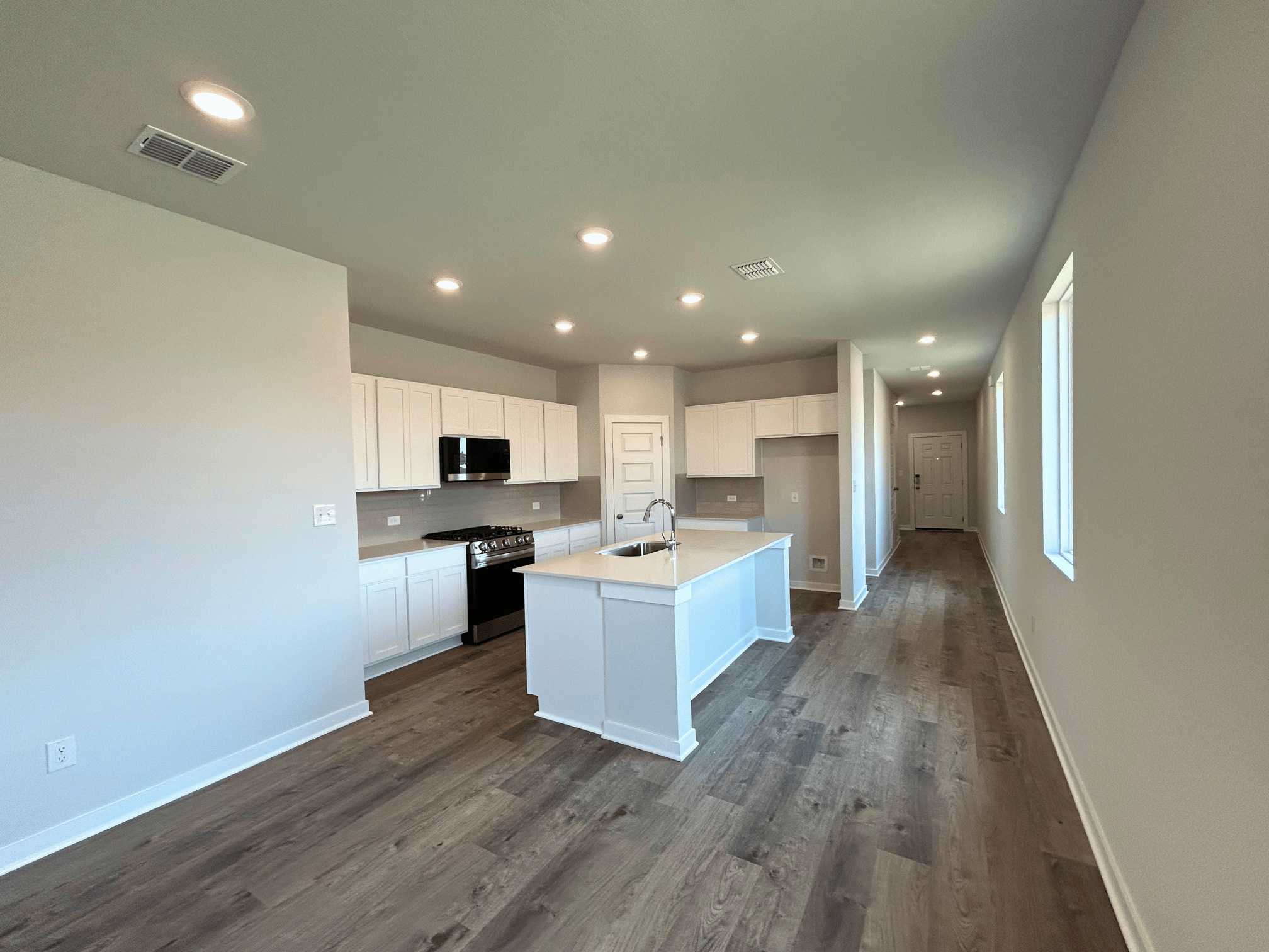 A kitchen with white cabinets.