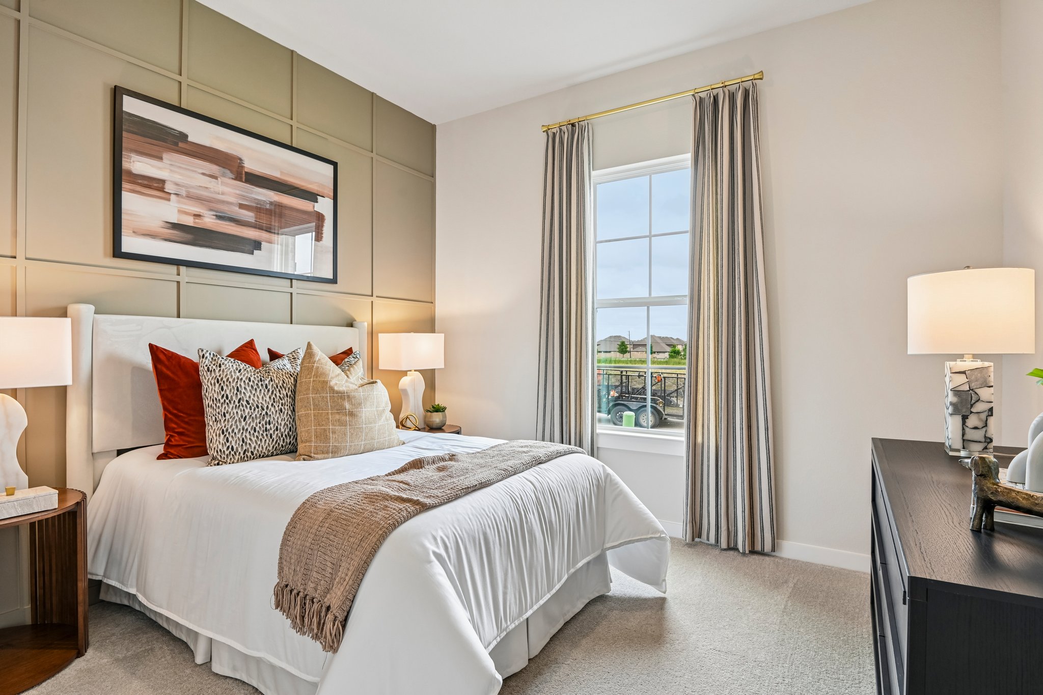 A bedroom with a large window.