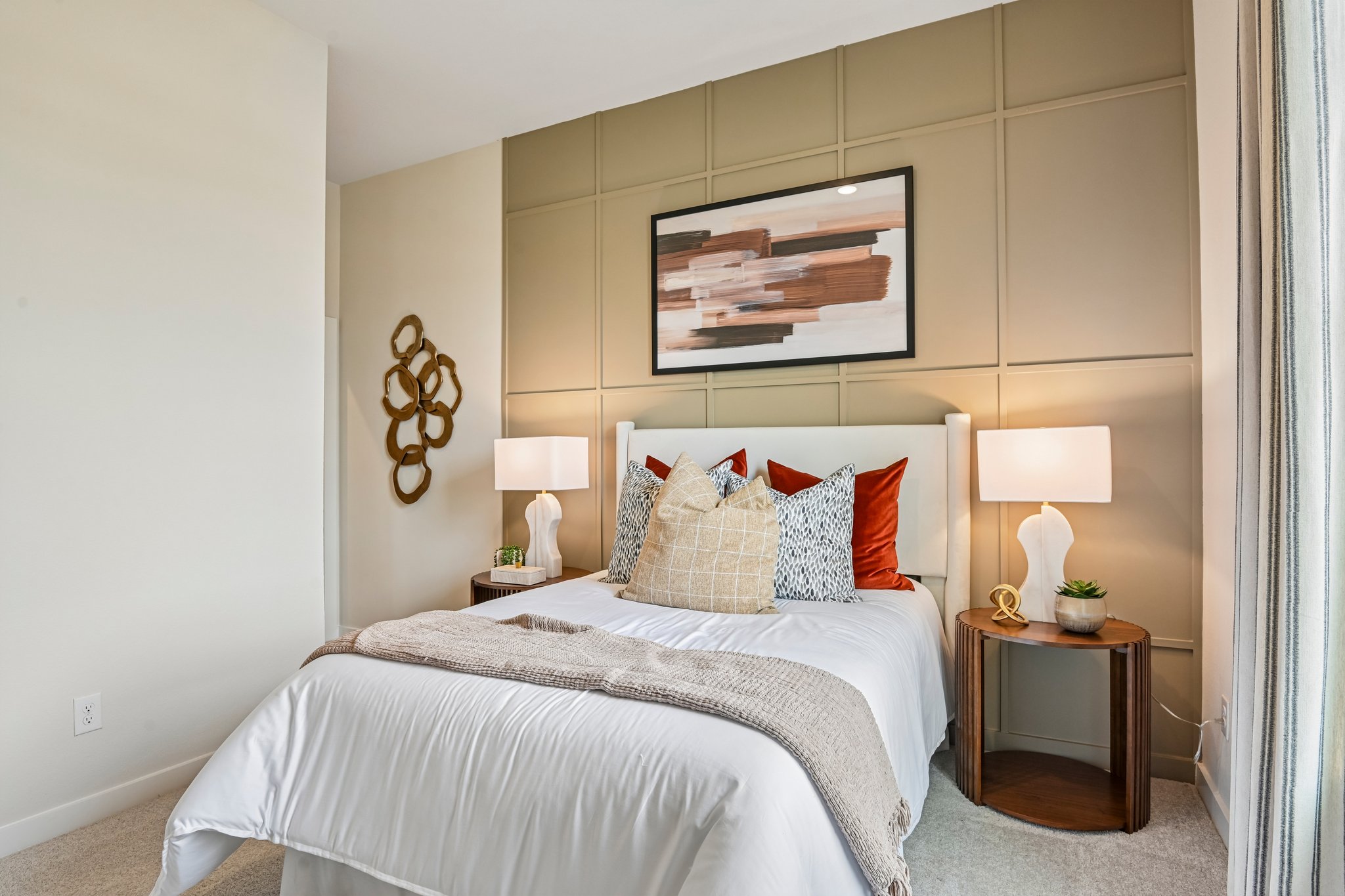 A bed with a white bed spread.