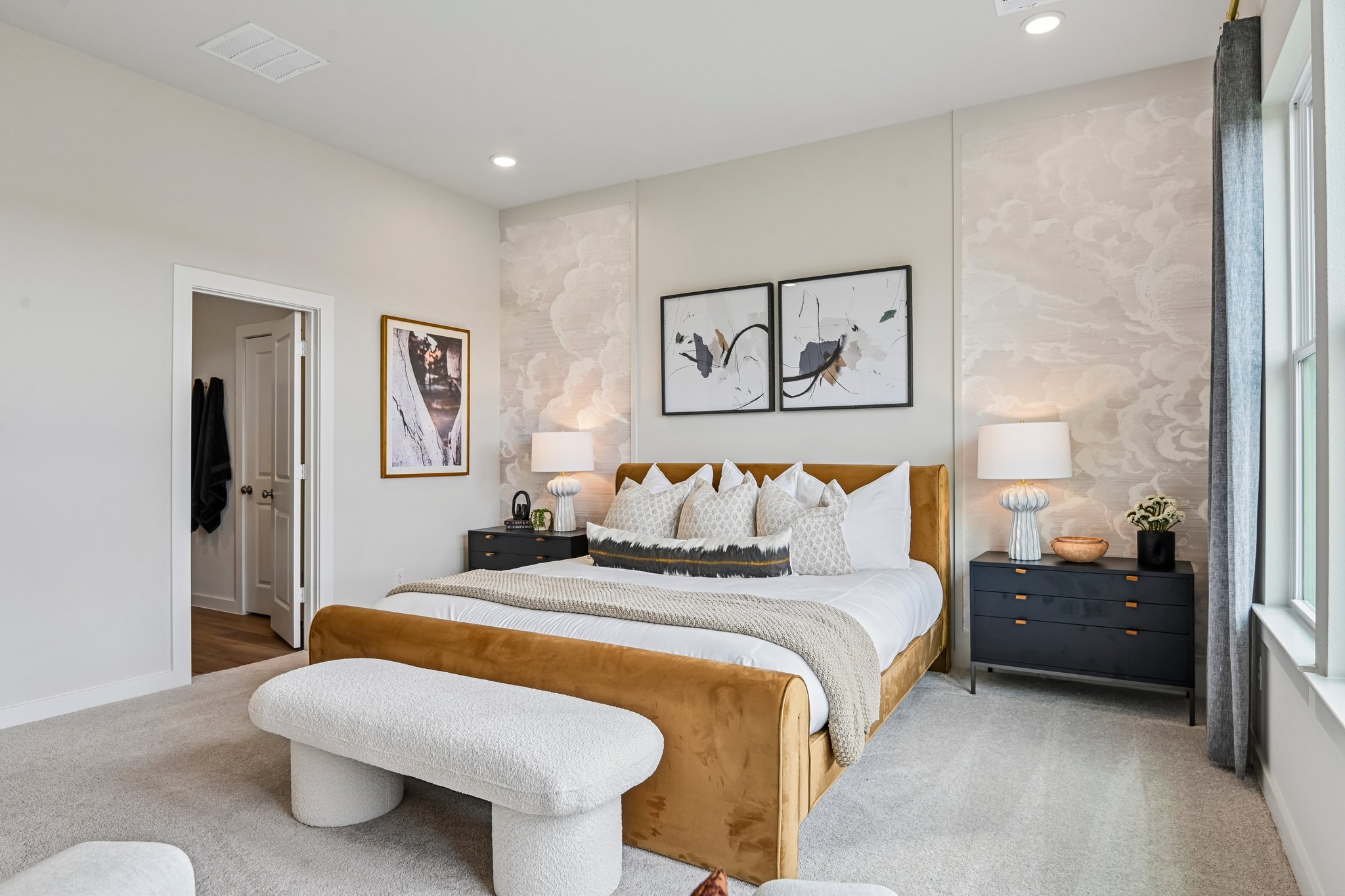 A bedroom with a bed and a chair.