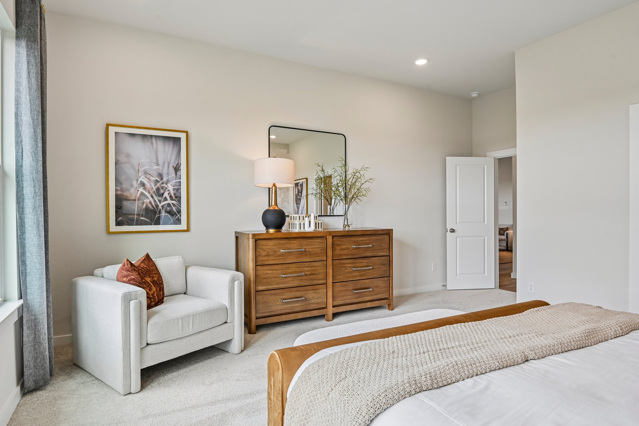 A bedroom with a bed and a couch.