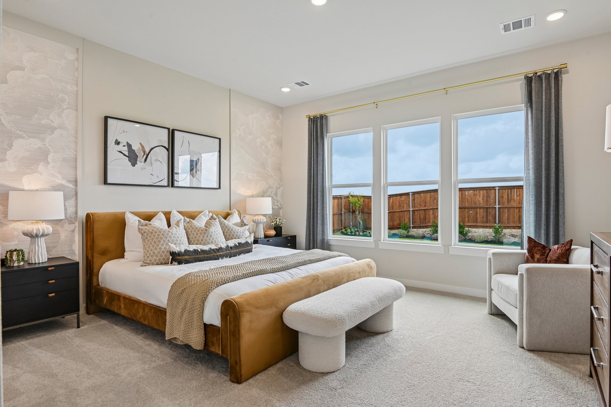 A bedroom with a large window.