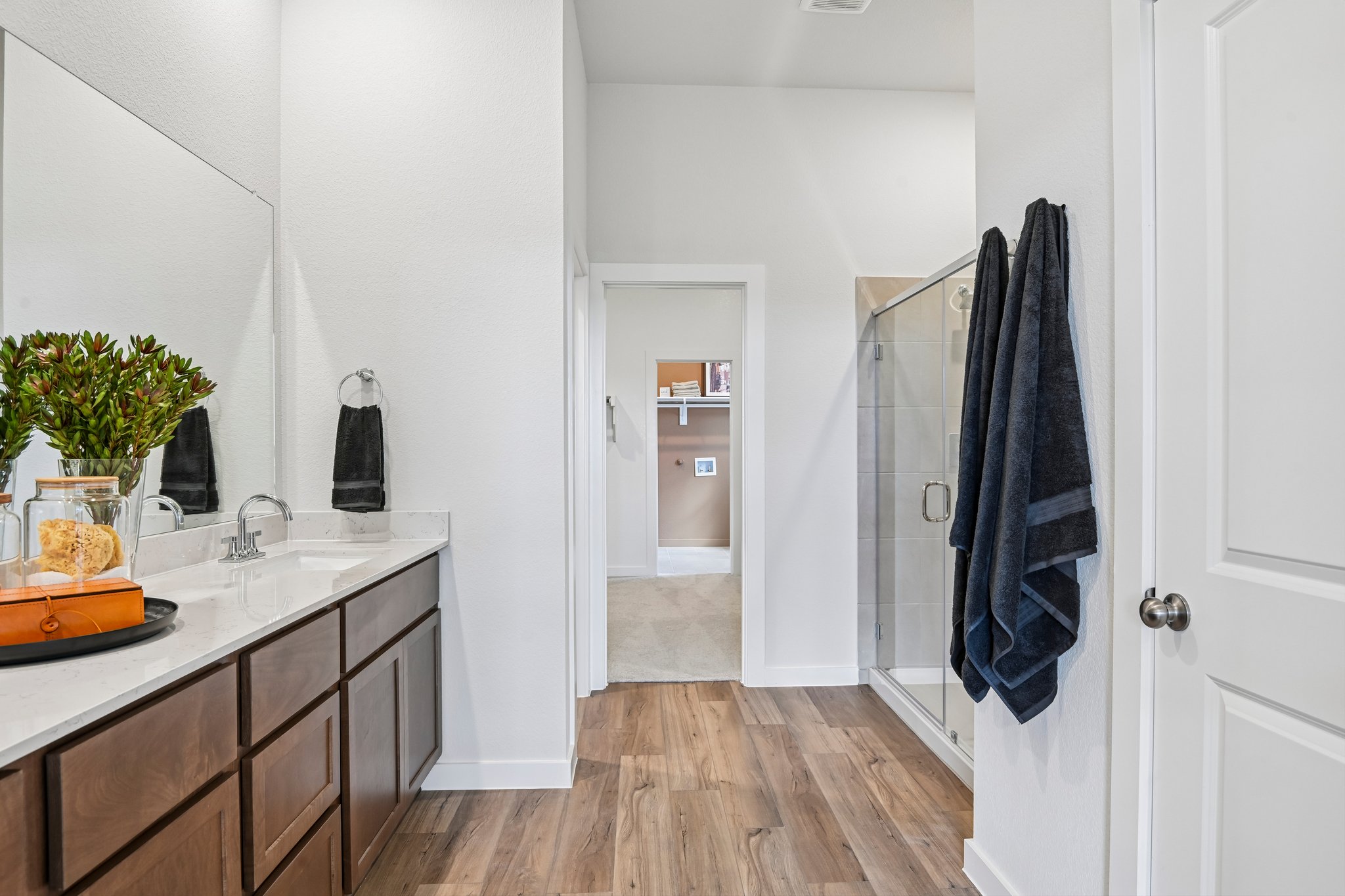 A bathroom with a sink and a shower.