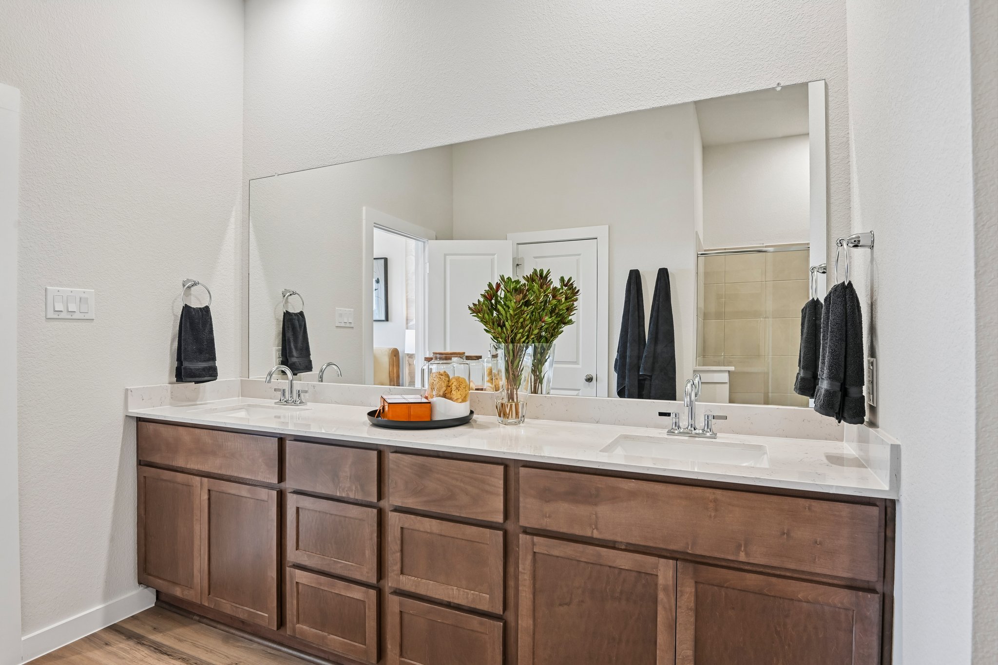 A bathroom with a large mirror.